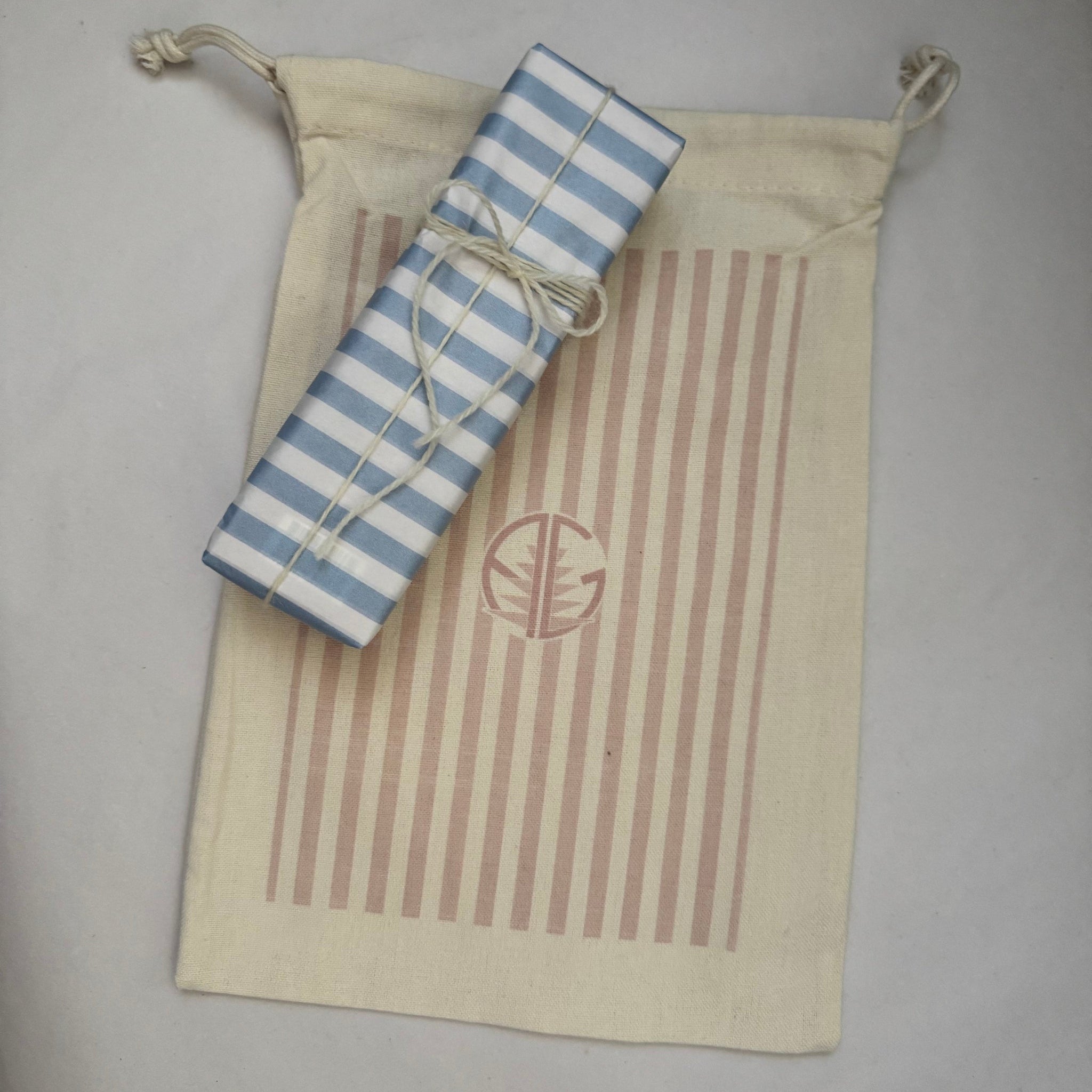 Cream and pink stripe gift bag and gift wrapped present.