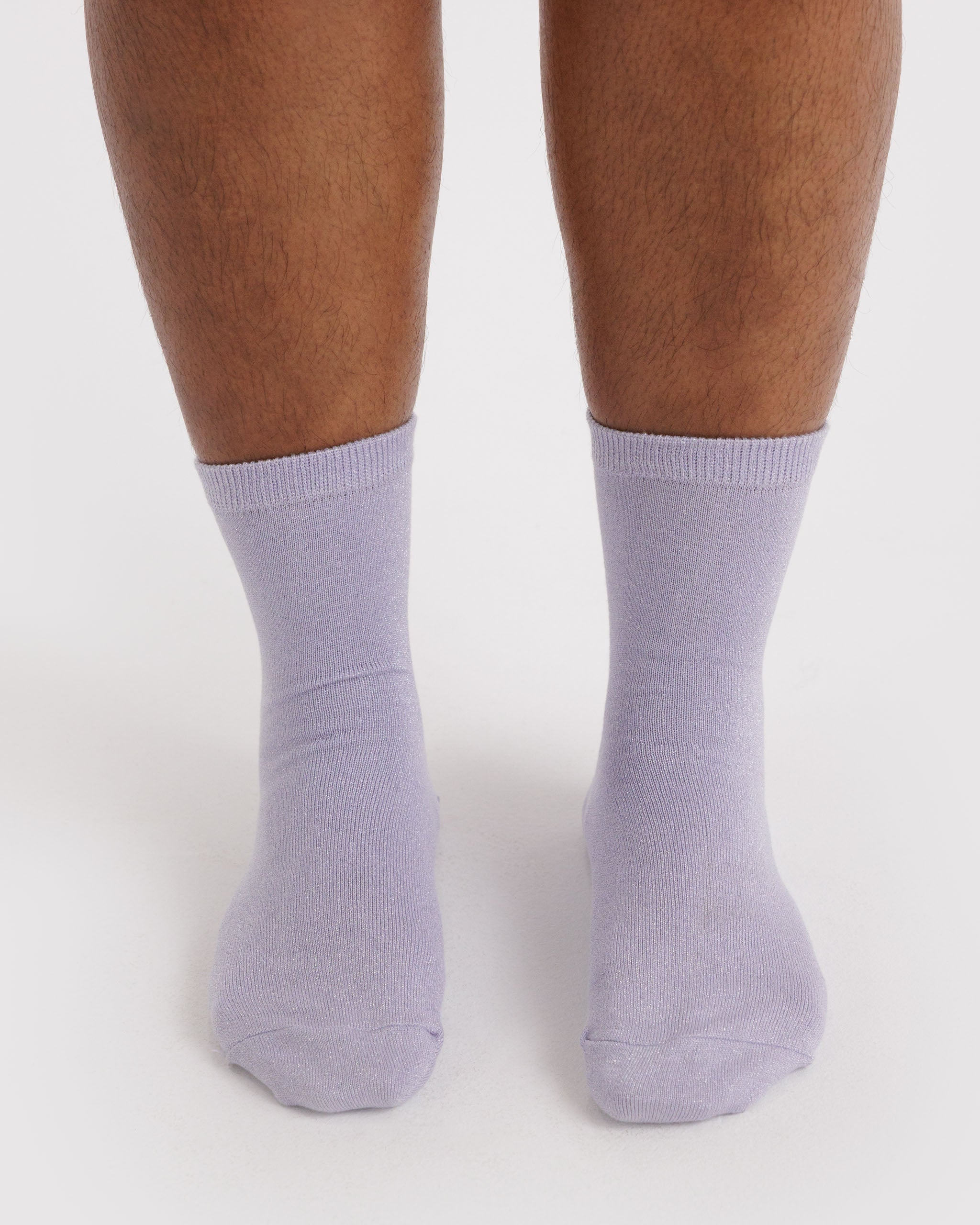 Purple with metallic thread socks worn by a person.