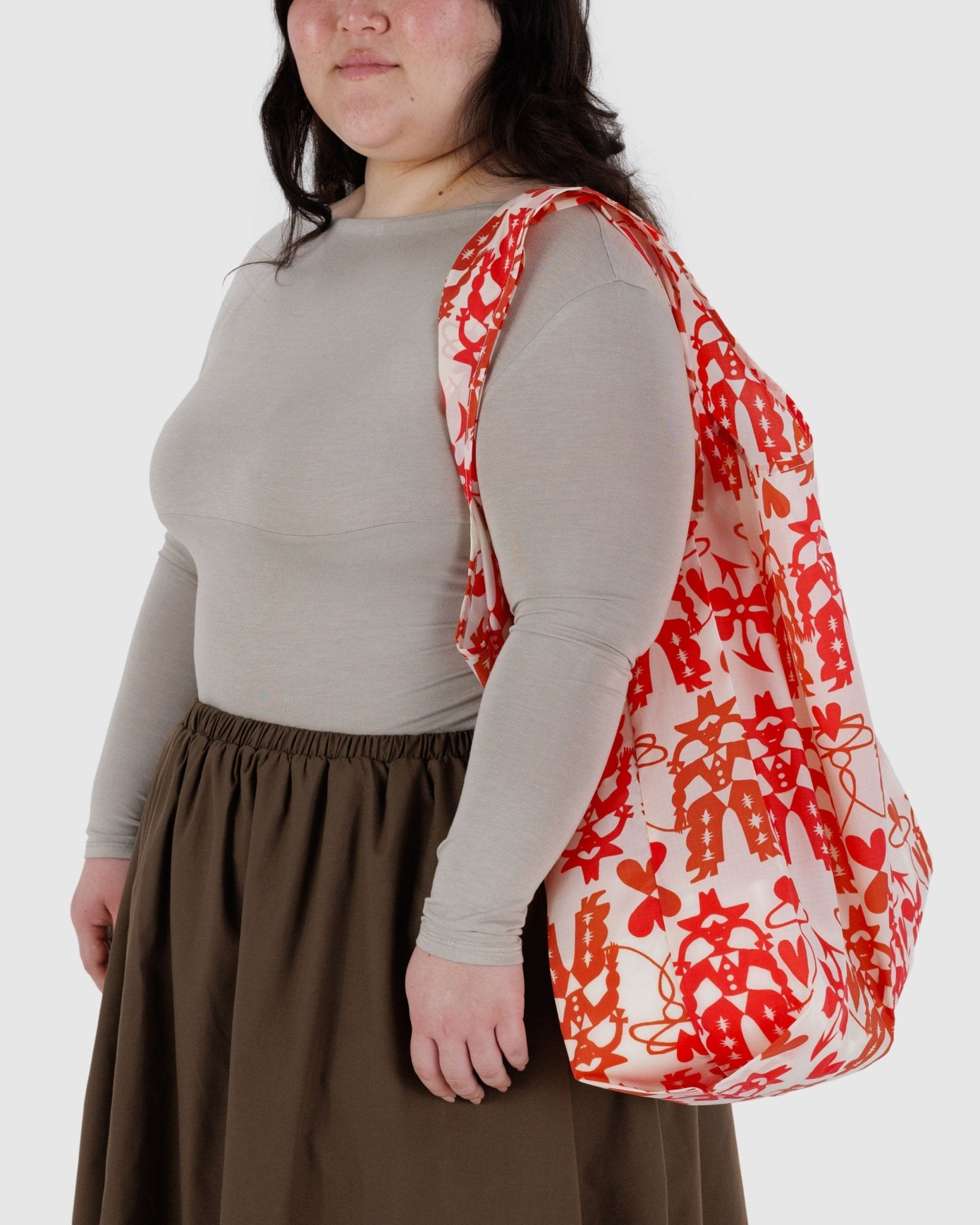 Person carrying a cowgirl print reusable tote on shoulder in big size.
