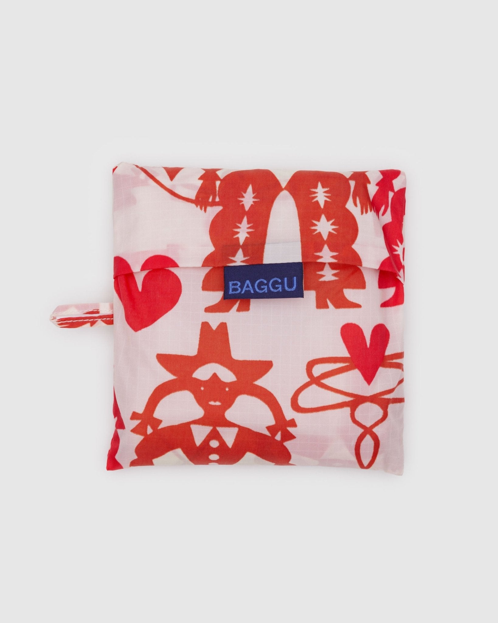 Pouch of reusable bag with cowgirl print and BAGGU logo on foldable top and hanging loop at the side.