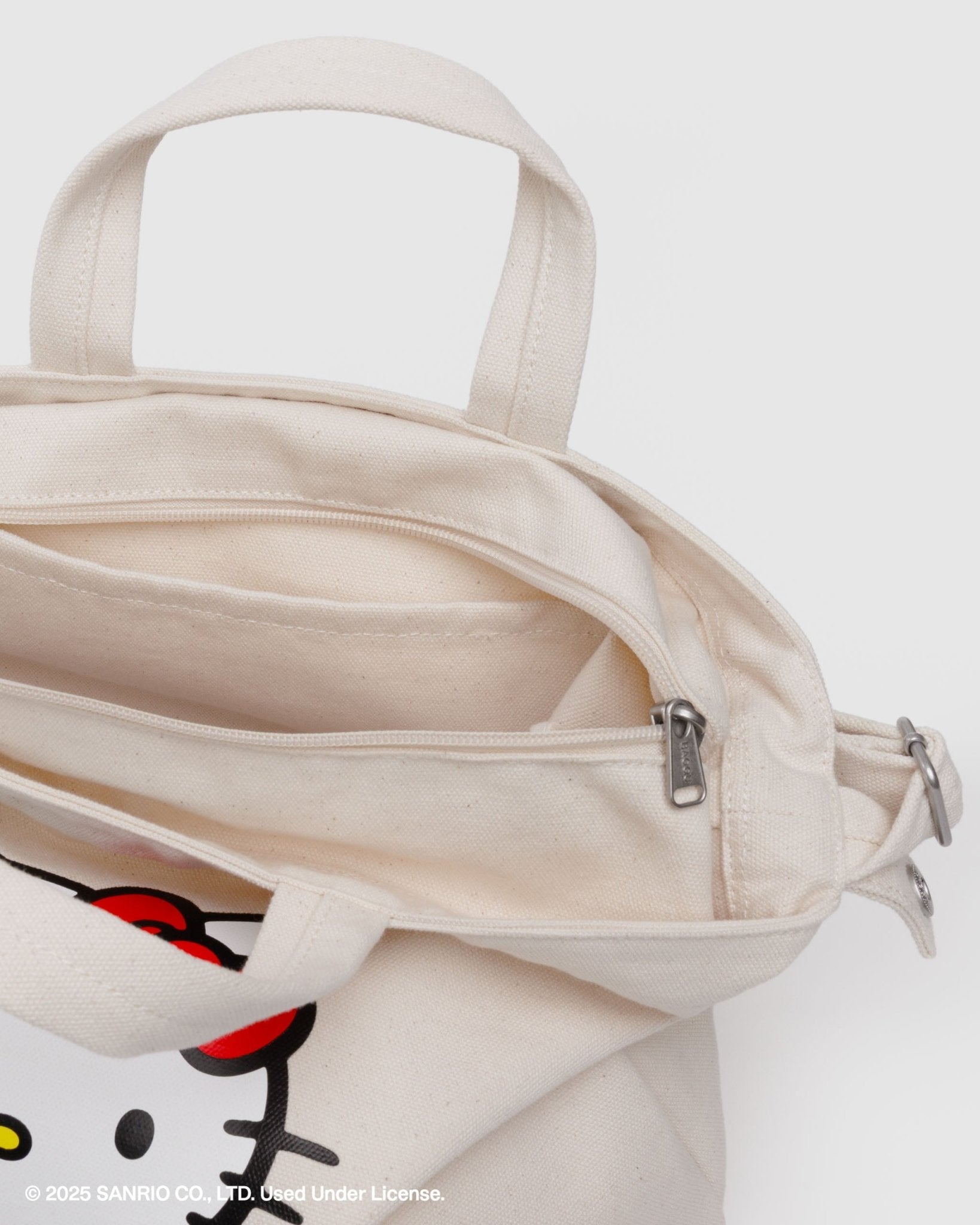 Ecru bag with a hello kitty character design.