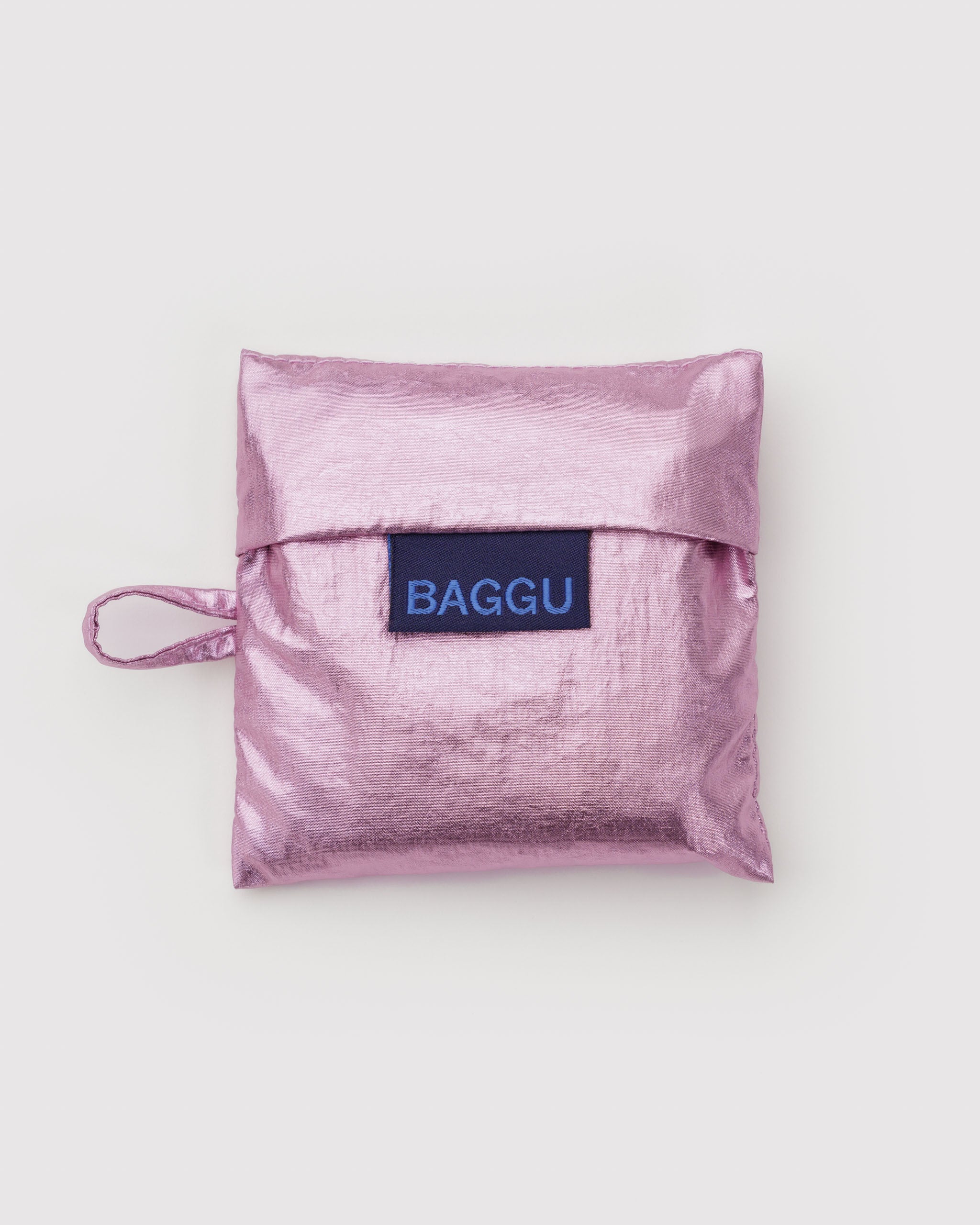 Metallic pink reusable bag pouch with 'BAGGU' logo.