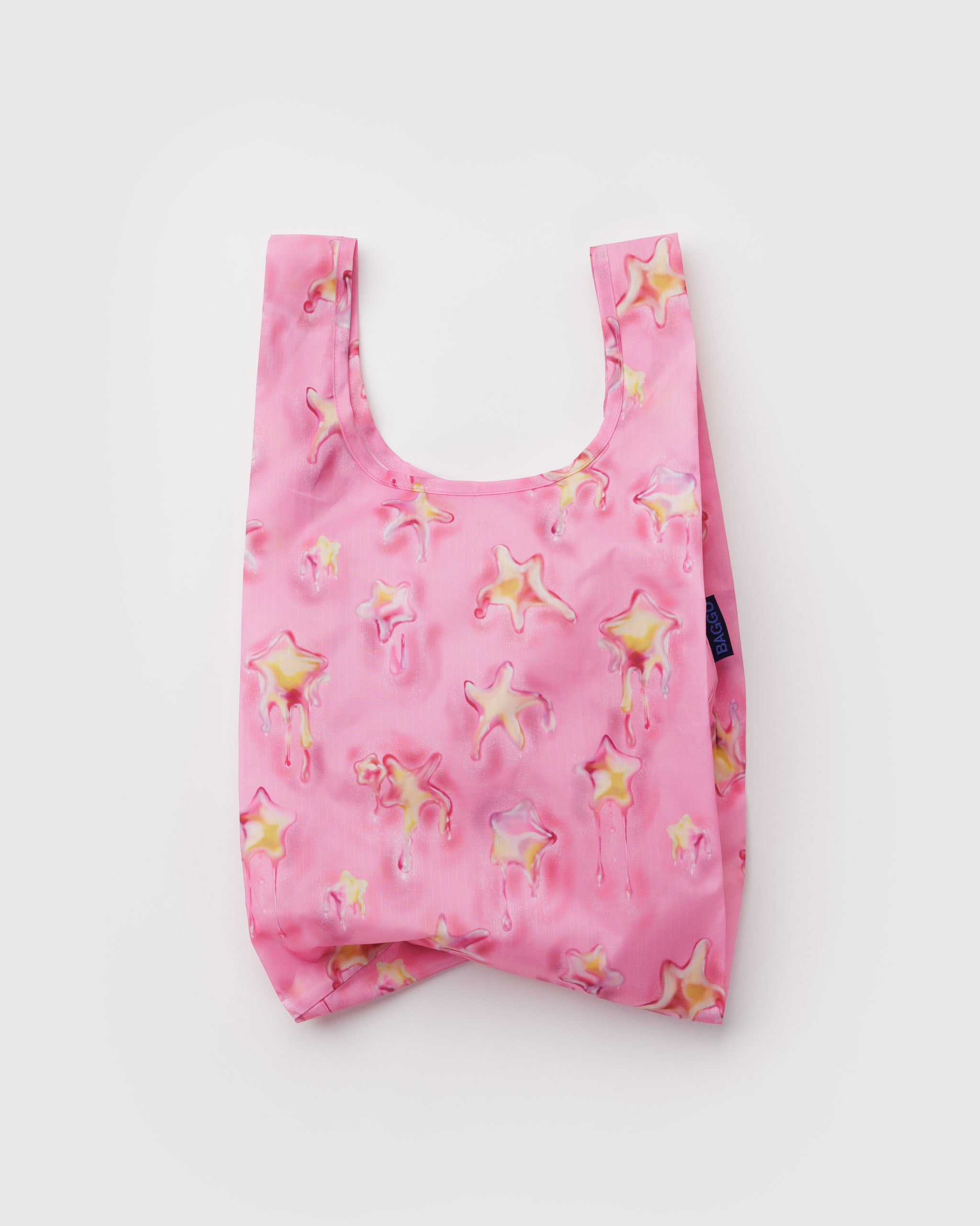 Pink reusable bag with yellow melting star pattern.