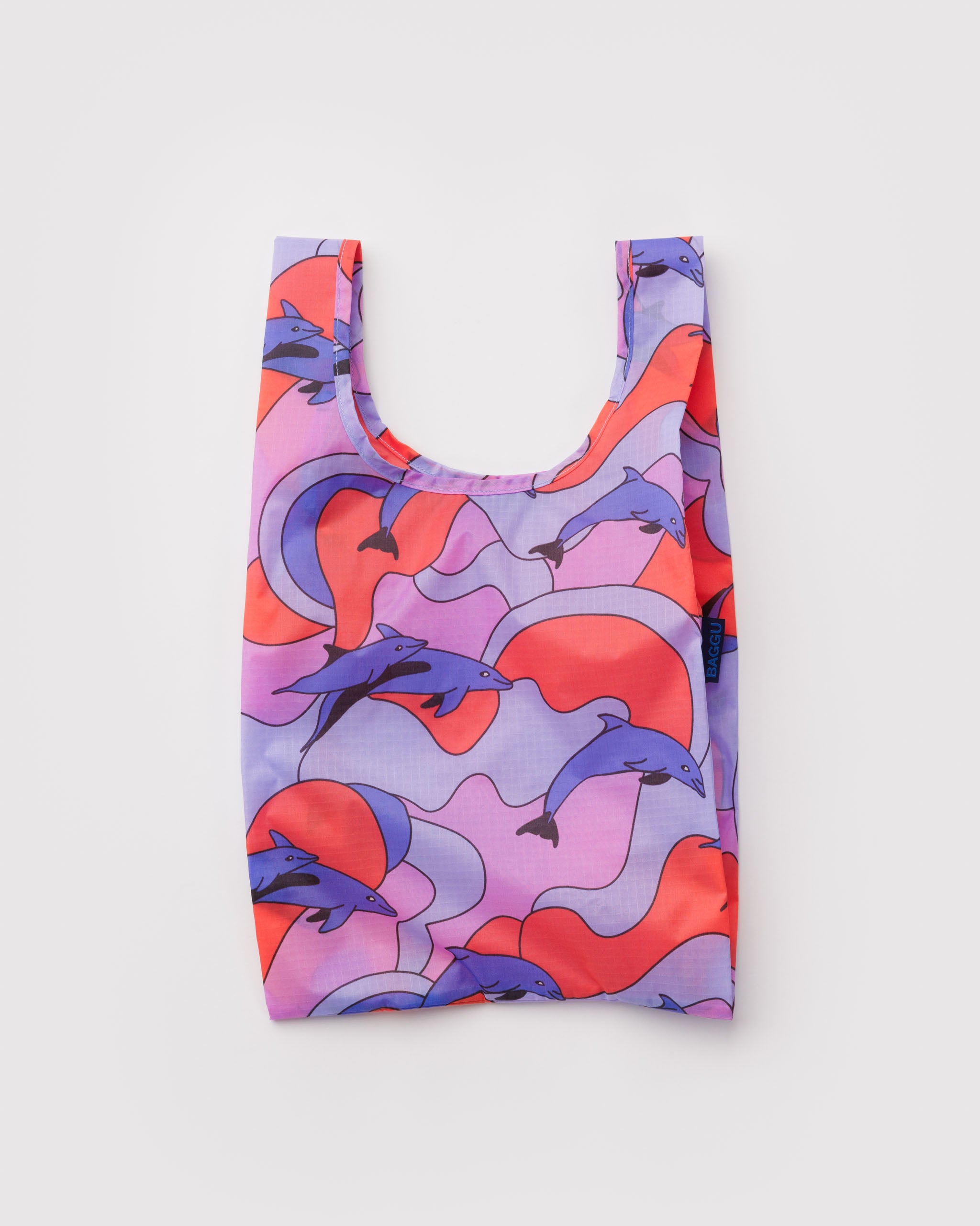 Reusable shopping bag with dolphins and a colourful pattern.