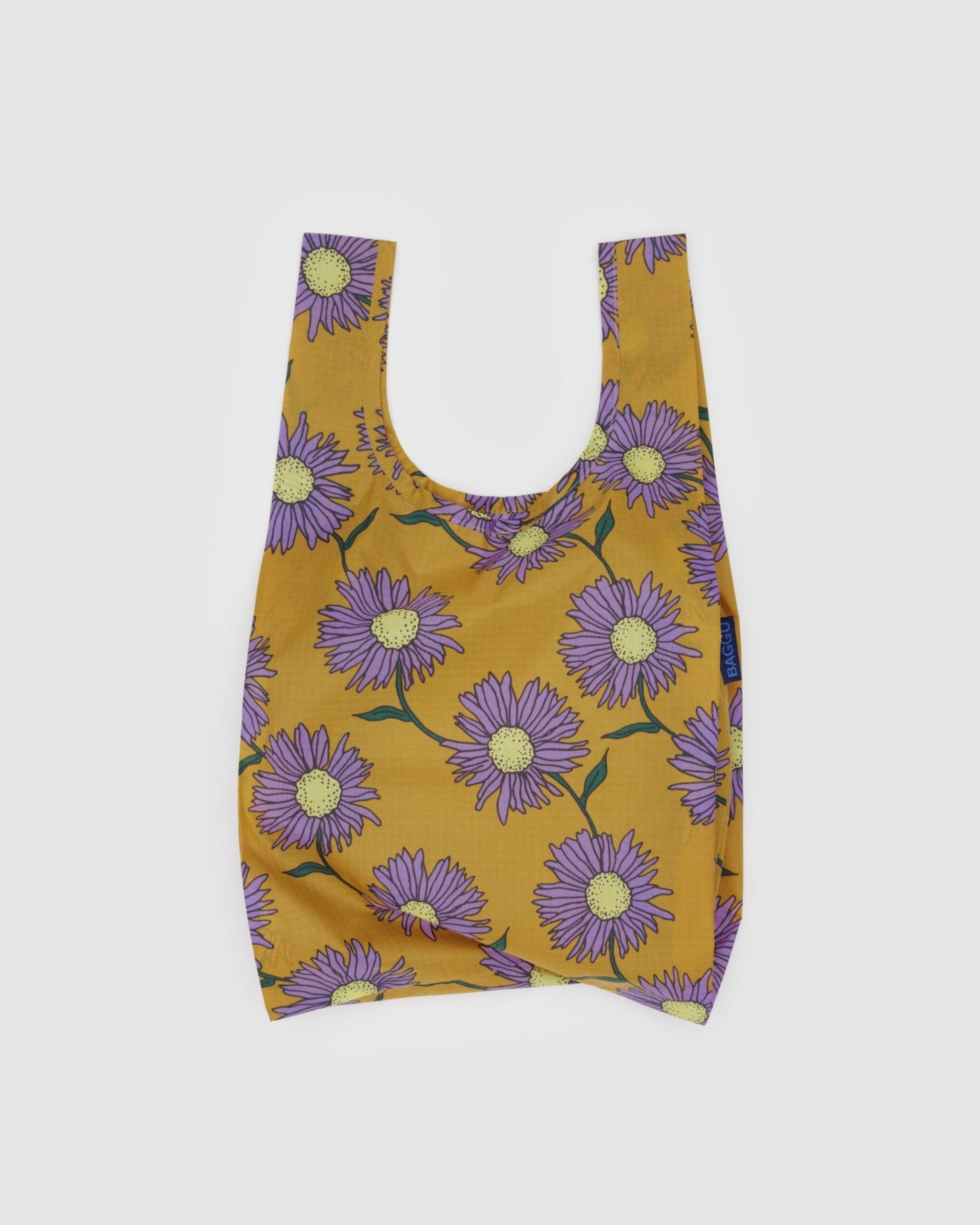 Daisy flower in purple on a mustard tote.