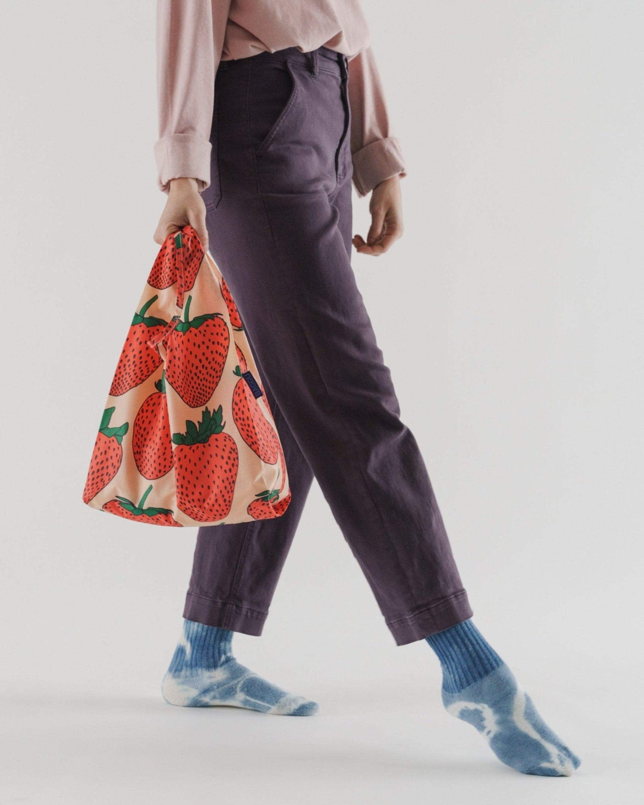 Person carrying a strawberry print nylon reusable shopping tote bag - ANNIE.G