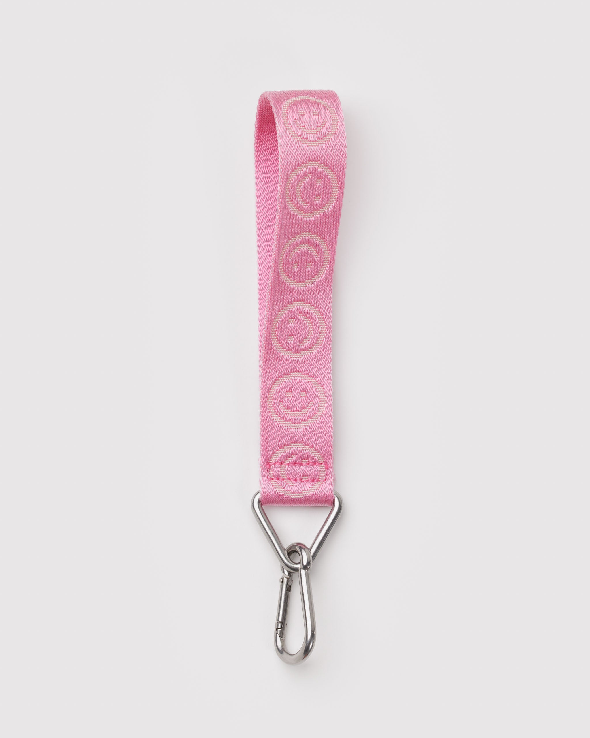 Pink webbing strap with smiley face design and metal clip on a triangular ring.