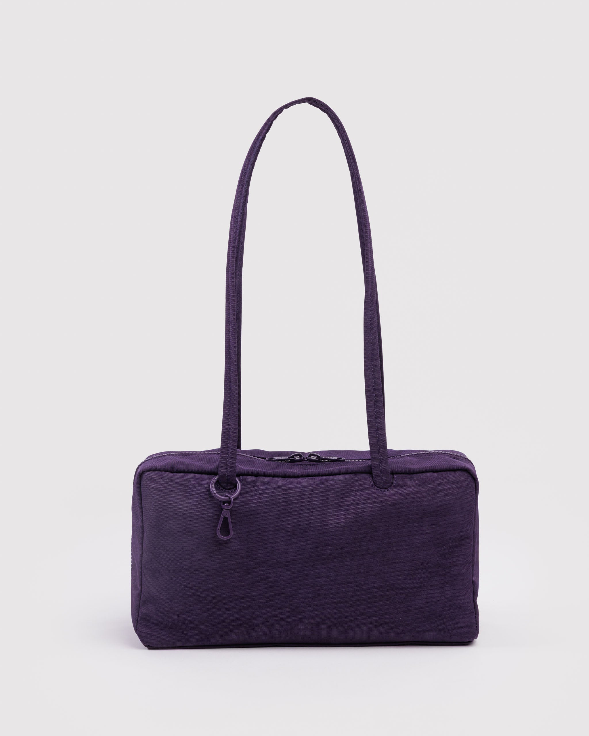 Purple shoulder bag with double carry handles, top double zips and tonal ring with a clip.