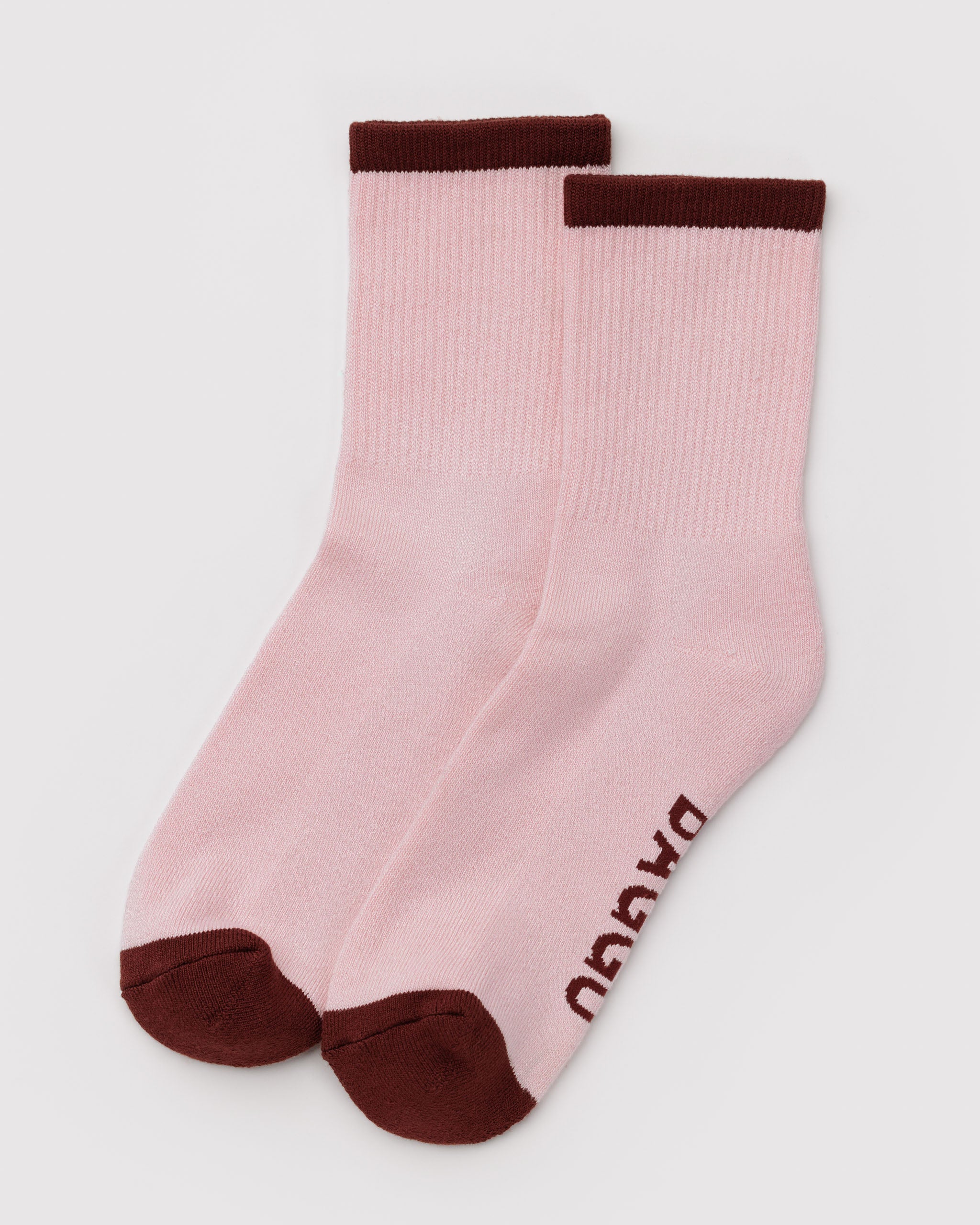 Pair of light pink crew socks with brown accents.