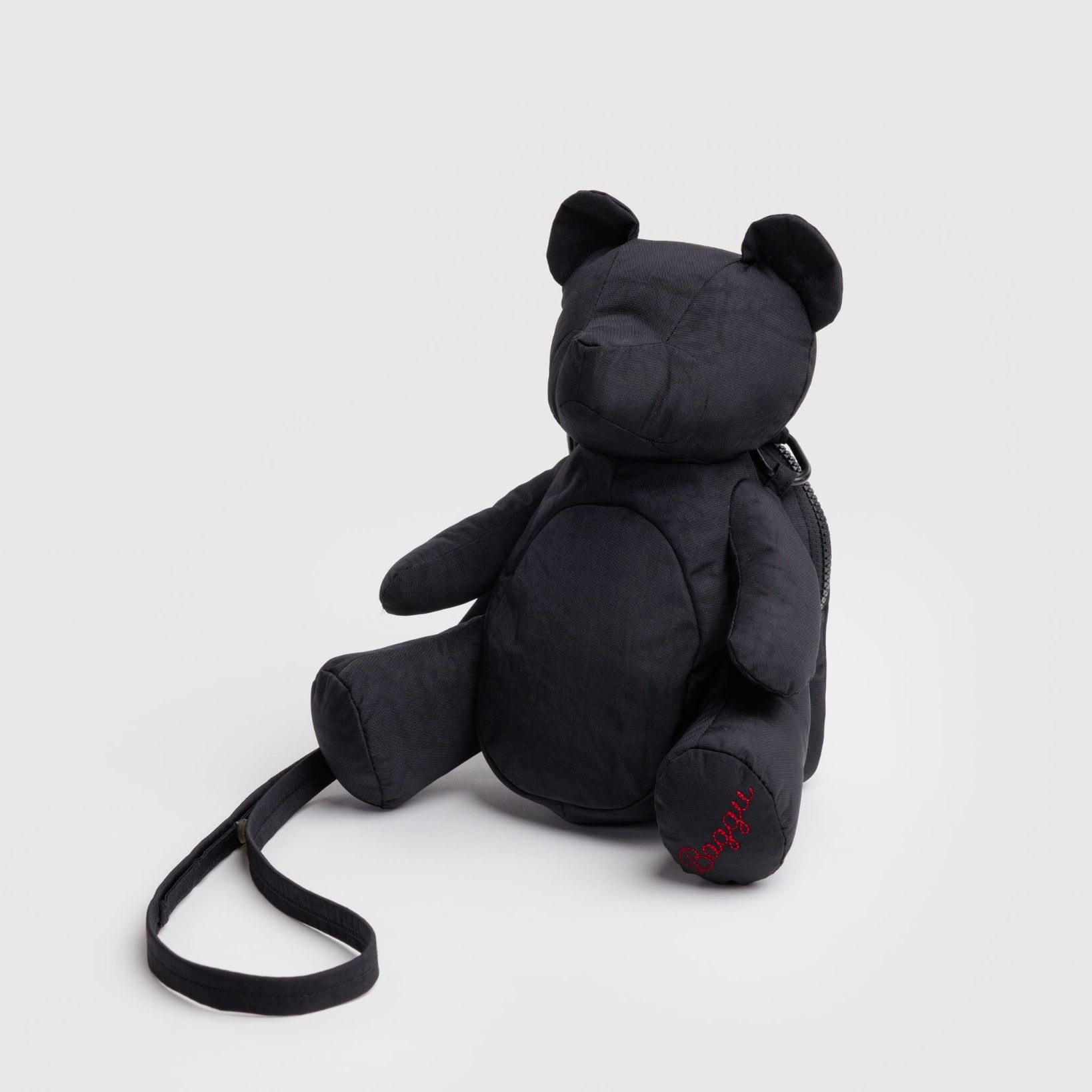 Black teddy bear bag with adjustable strap and red BAGGU embroidered on foot.
