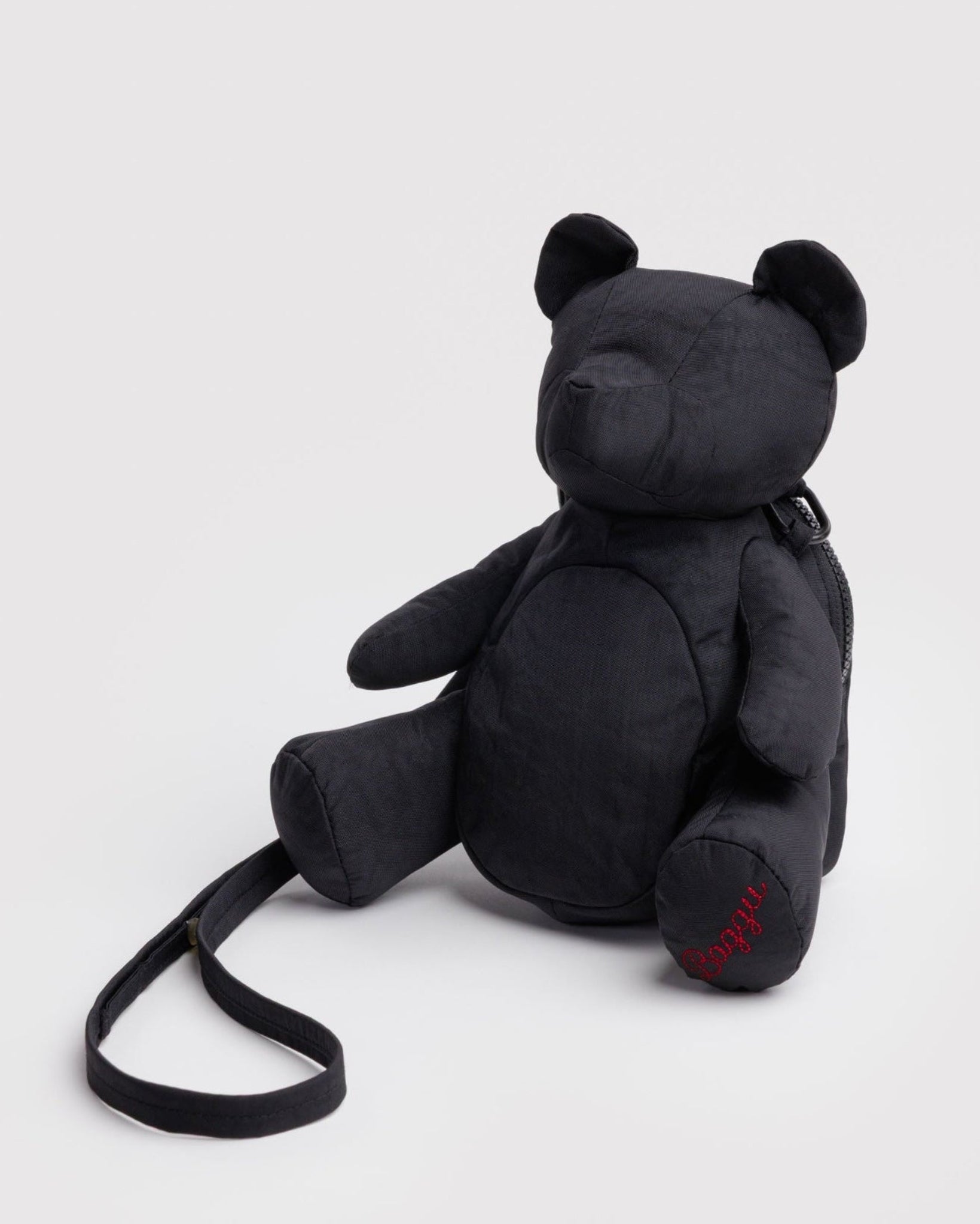 Black teddy bear bag with adjustable strap and red BAGGU embroidered on foot.