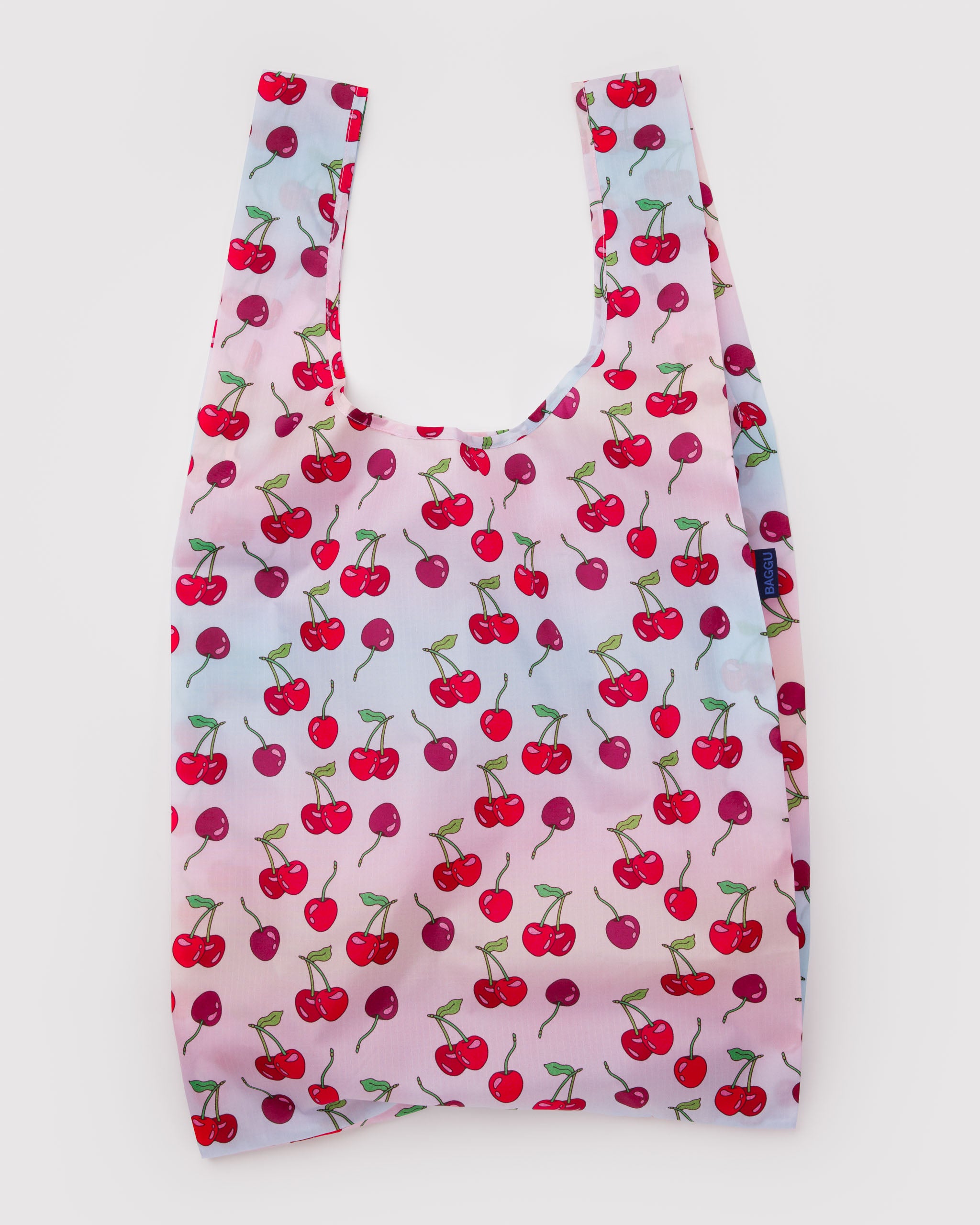 Light pink and blue graduated colour reusable tote bag with red cherry pattern.