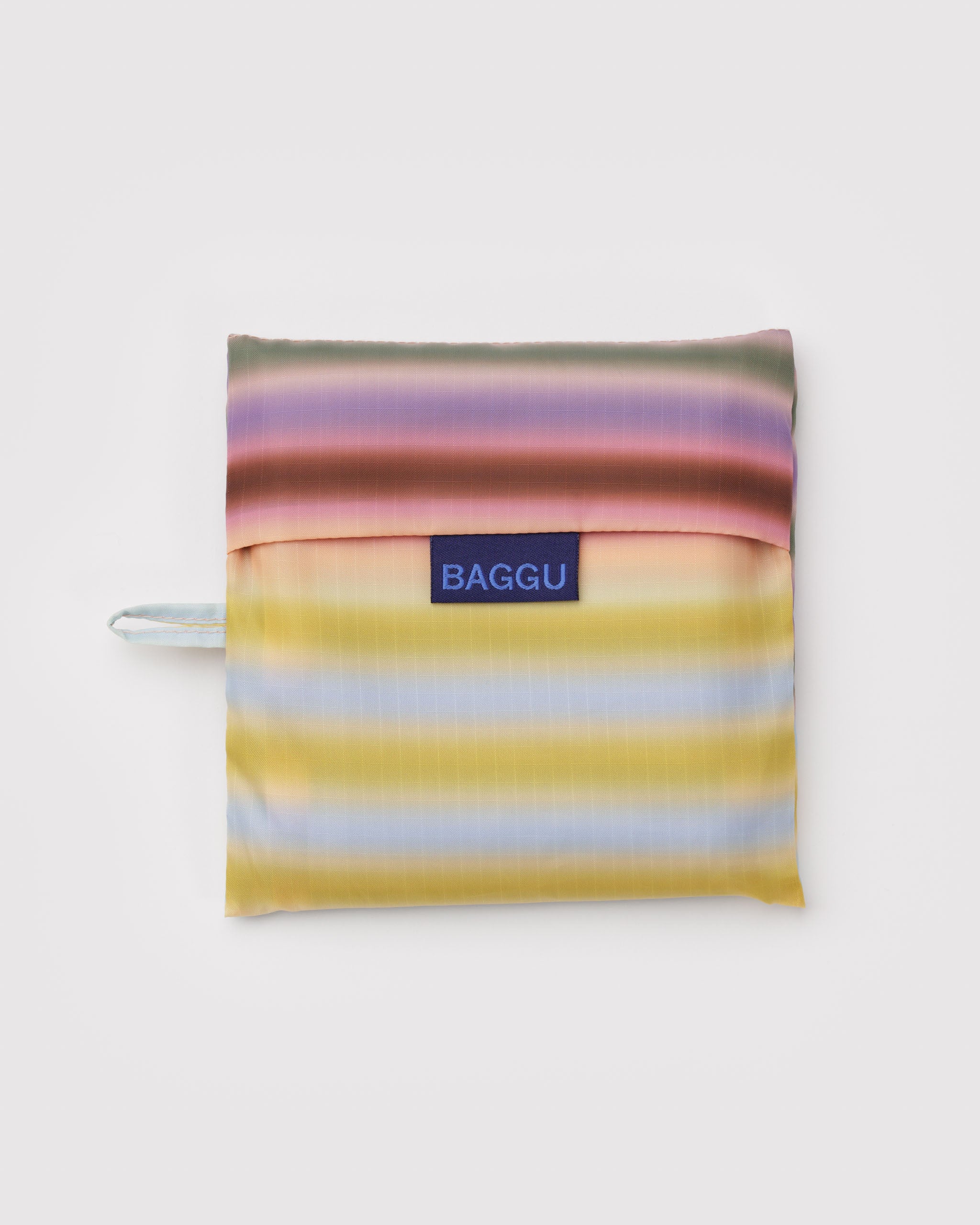 Multicolored striped 'BAGGU' labelled pouch with hanging loop.