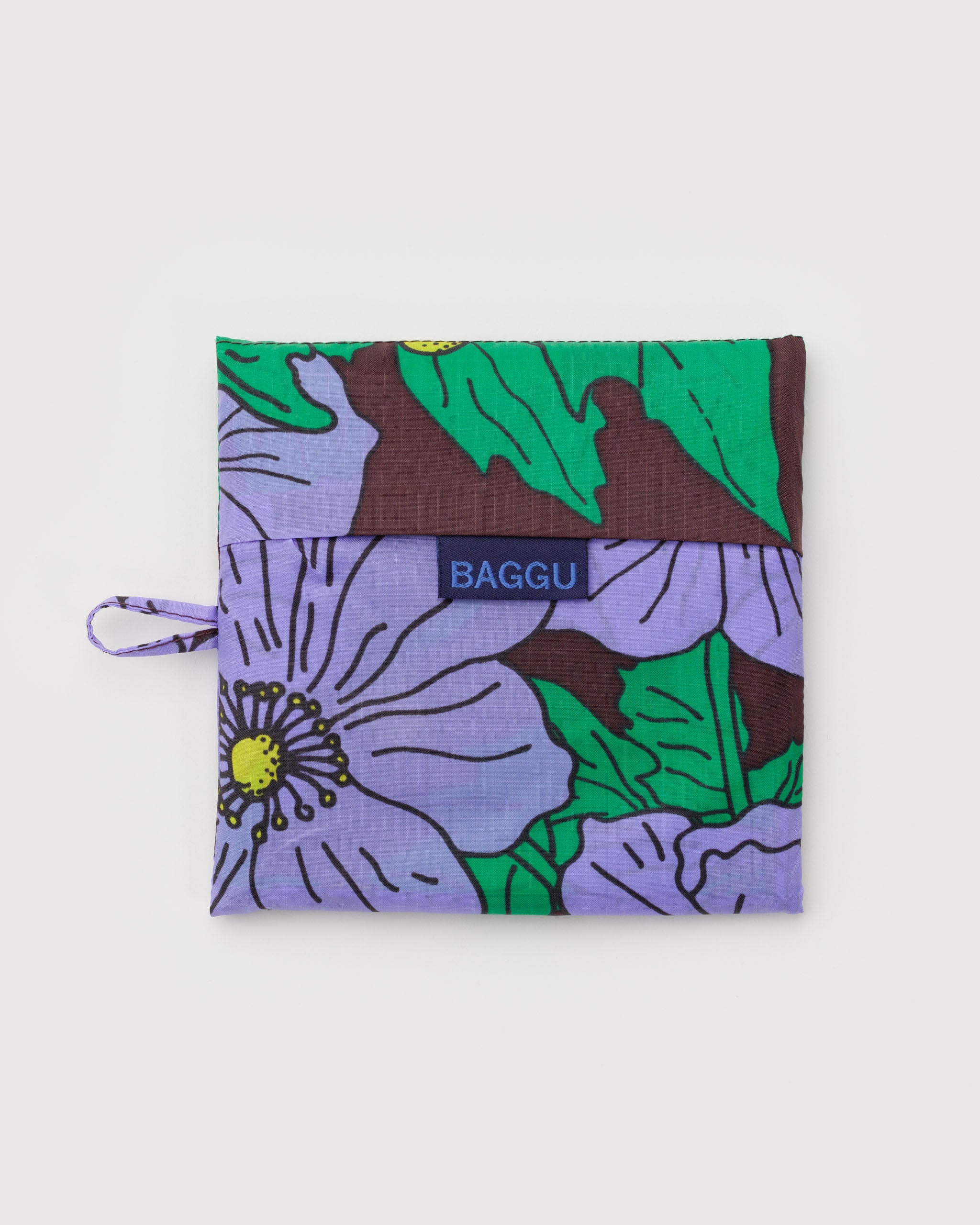 Maroon background with purple poppy floral-patterned reusable bag pouch with 'BAGGU' branding and hanging loop.