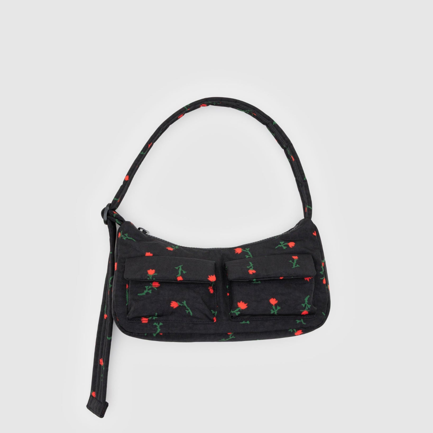 Black cargo handbag with red wildflower floral pattern, top zip and adjustable quilted strap with two front pockets.