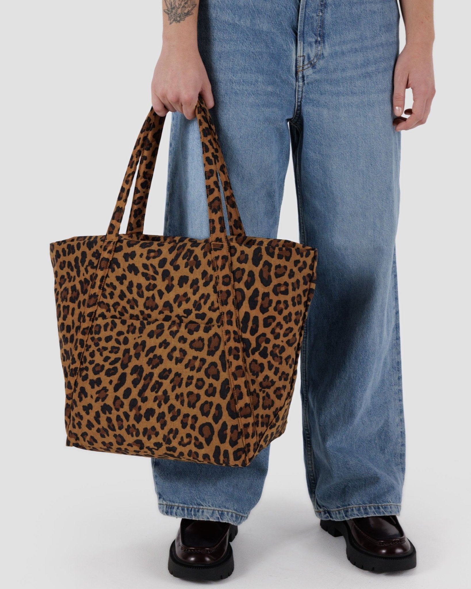 Person carrying the leopard print cloud bag by the handles - ANNIE.G