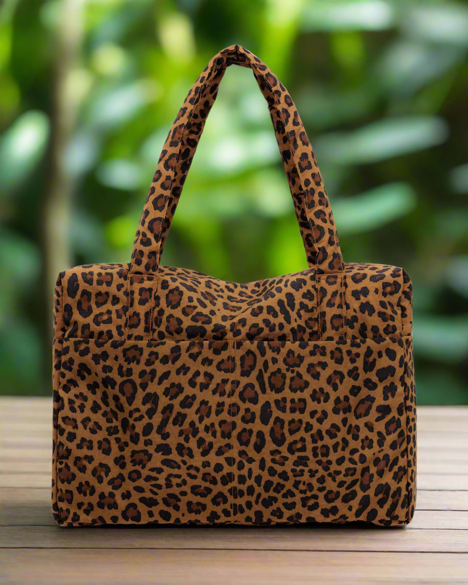 leopard-print-carry-on-bag-front-on-table-in-jungle