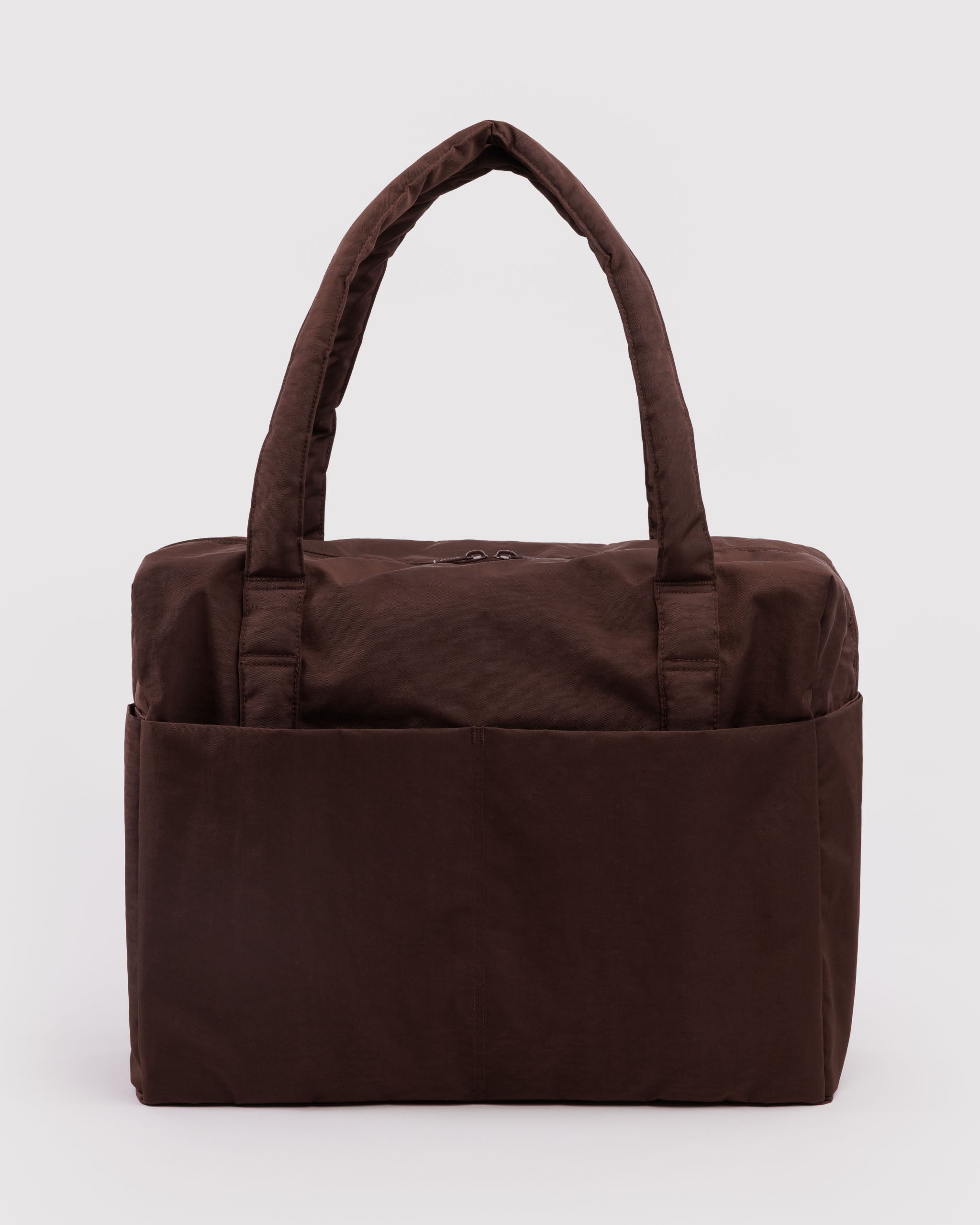Brown tote bag with carry handles, zip top and front pockets.