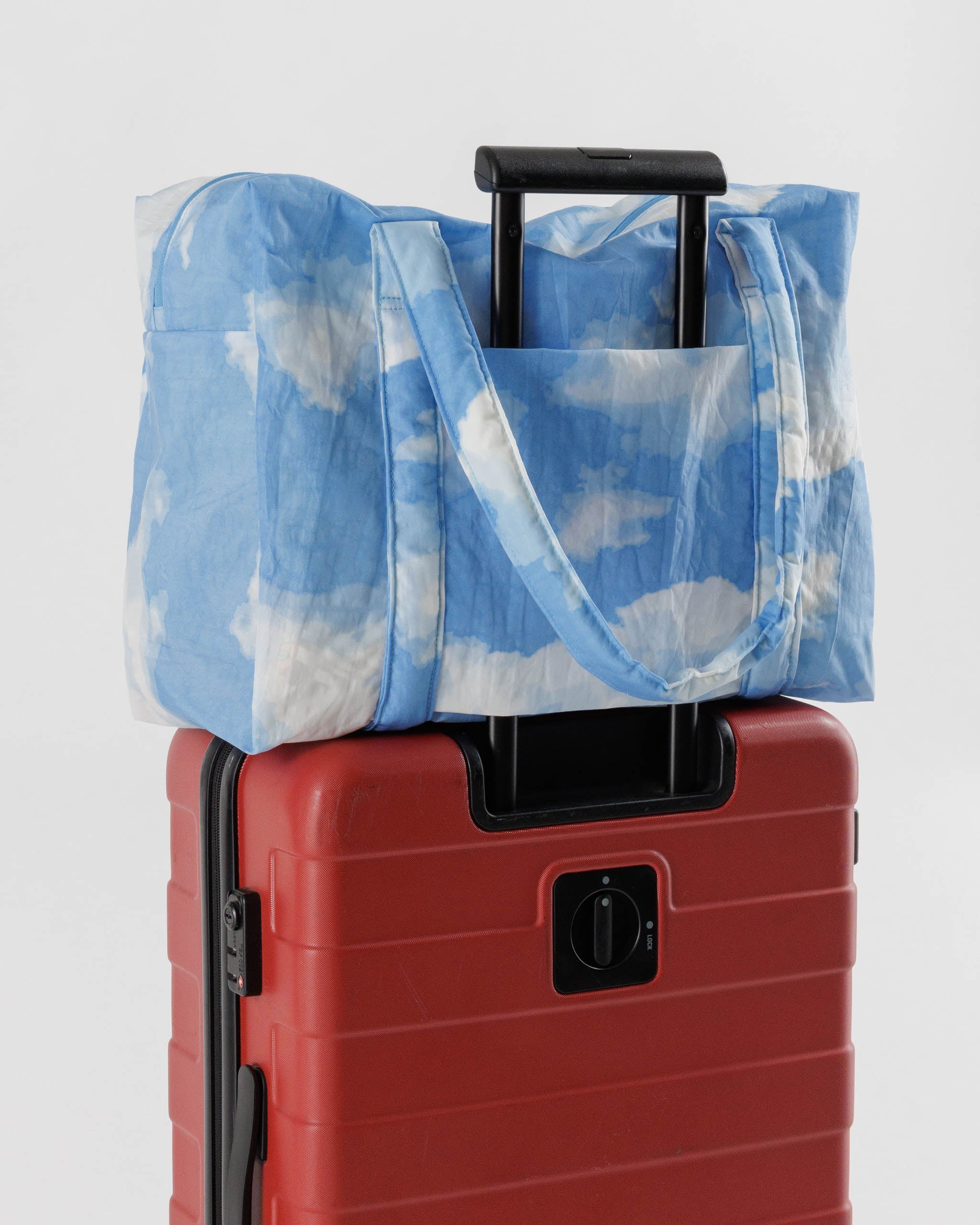 baggu-carry-on-bag-sitting-on-top-of-suitcase