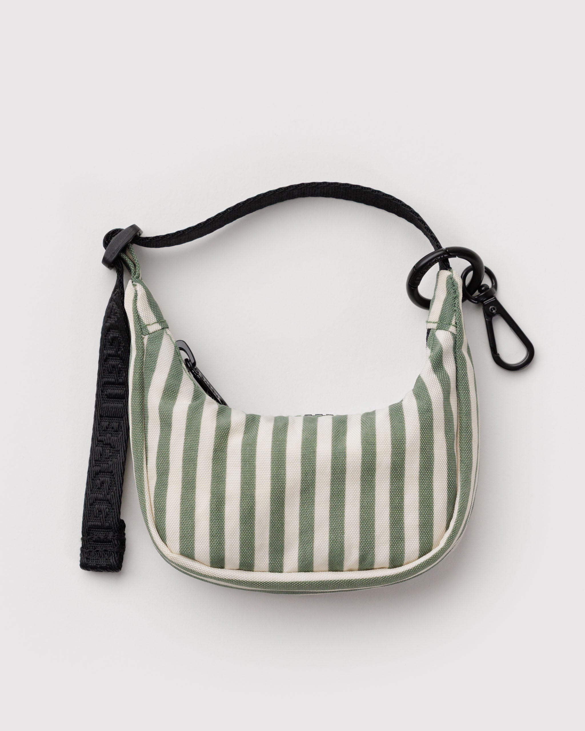 Green and white striped cresent shaped bag charm with a black adjustable strap, zip closure and metal clip