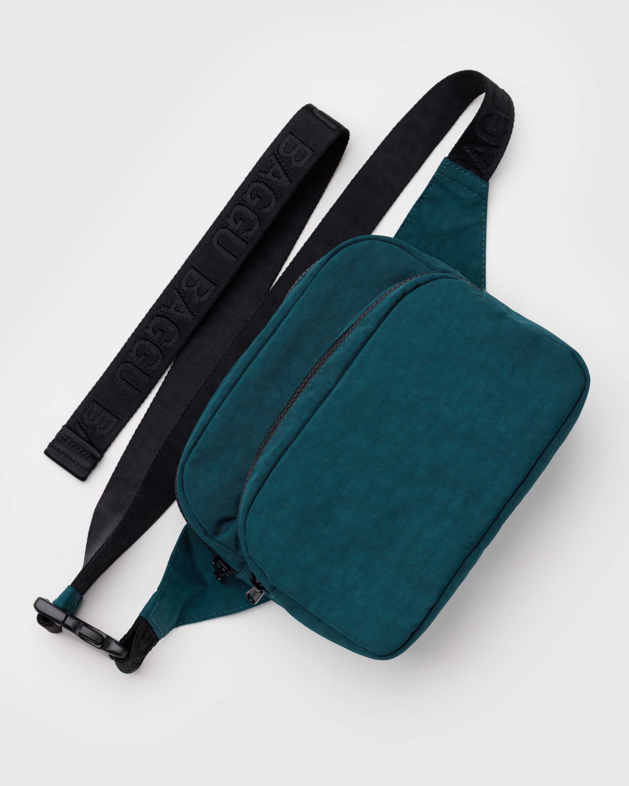 Teal waist bag with black adjustable strap and two zip pouches.