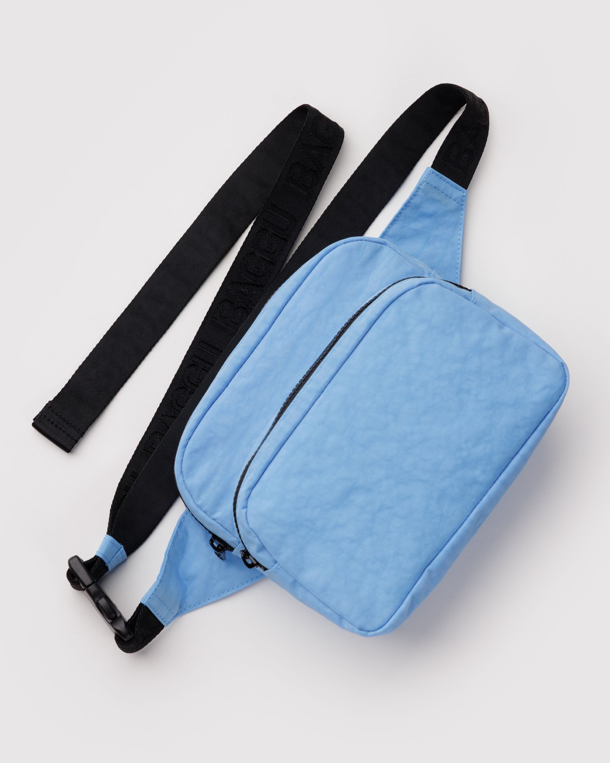 Blue waist bag with an adjustable black strap with clip and two zip pouches.