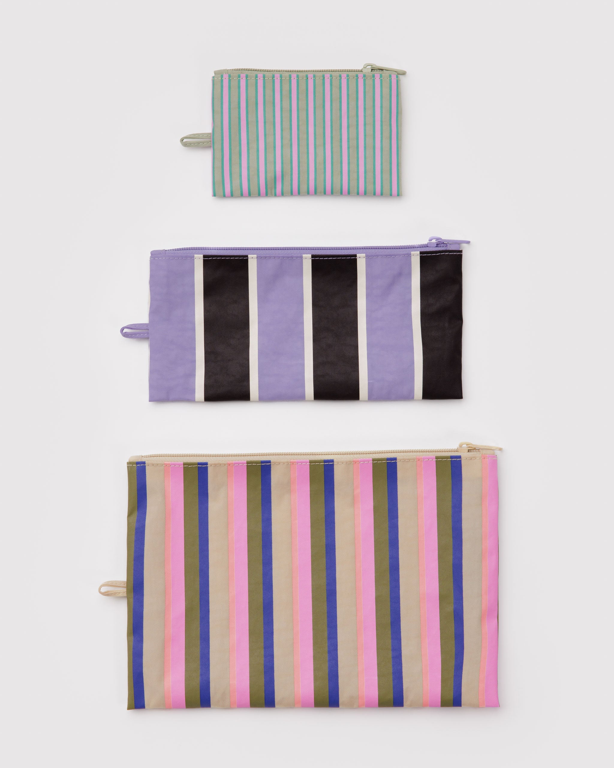 Three flat zip top colourful and multi striped pouches in pastel colours and with a hanging loop at the side.