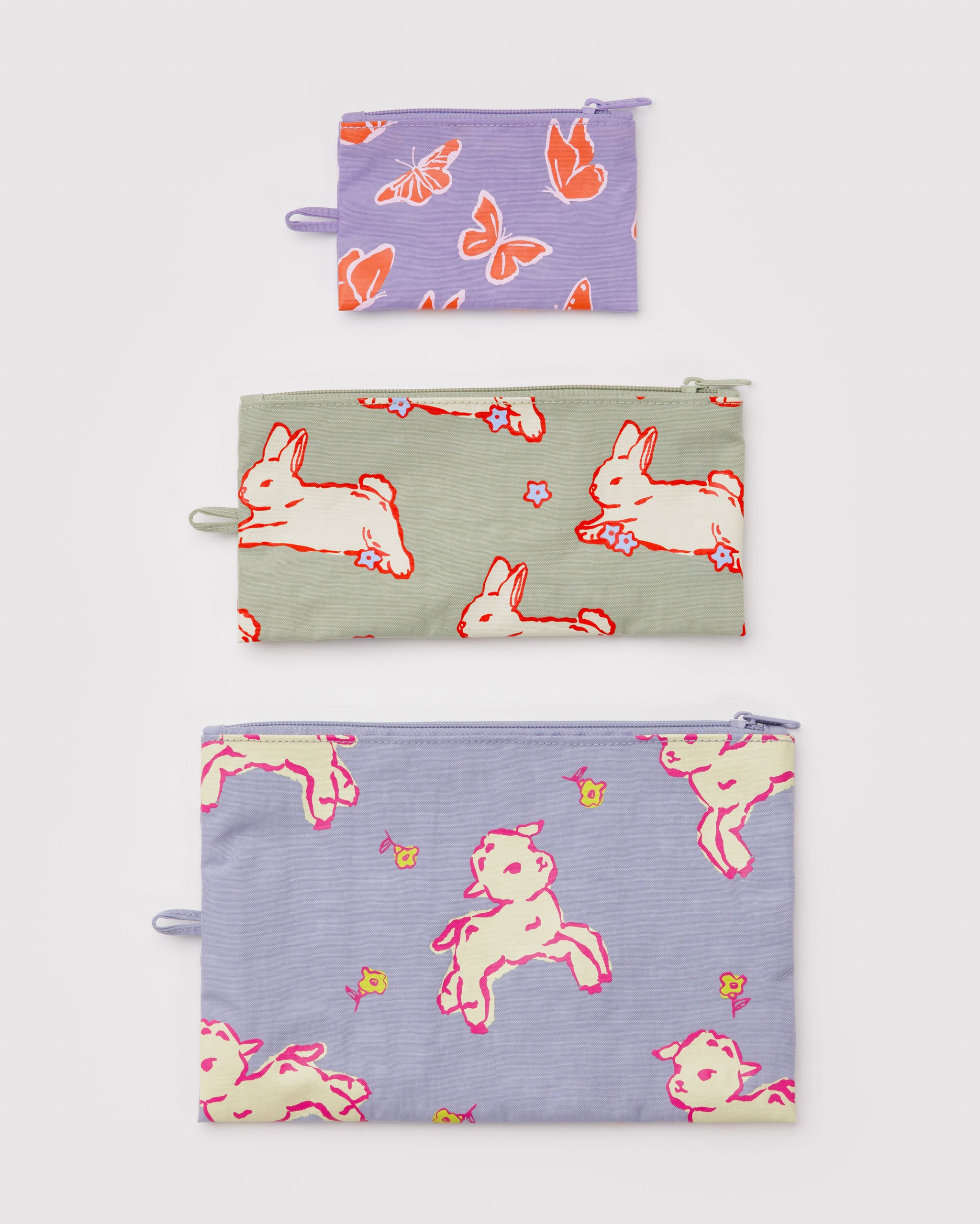 Three flat zip top pouches in pastel colours with rabbit, lamb and butterfly patterns and a hanging loop at the side.