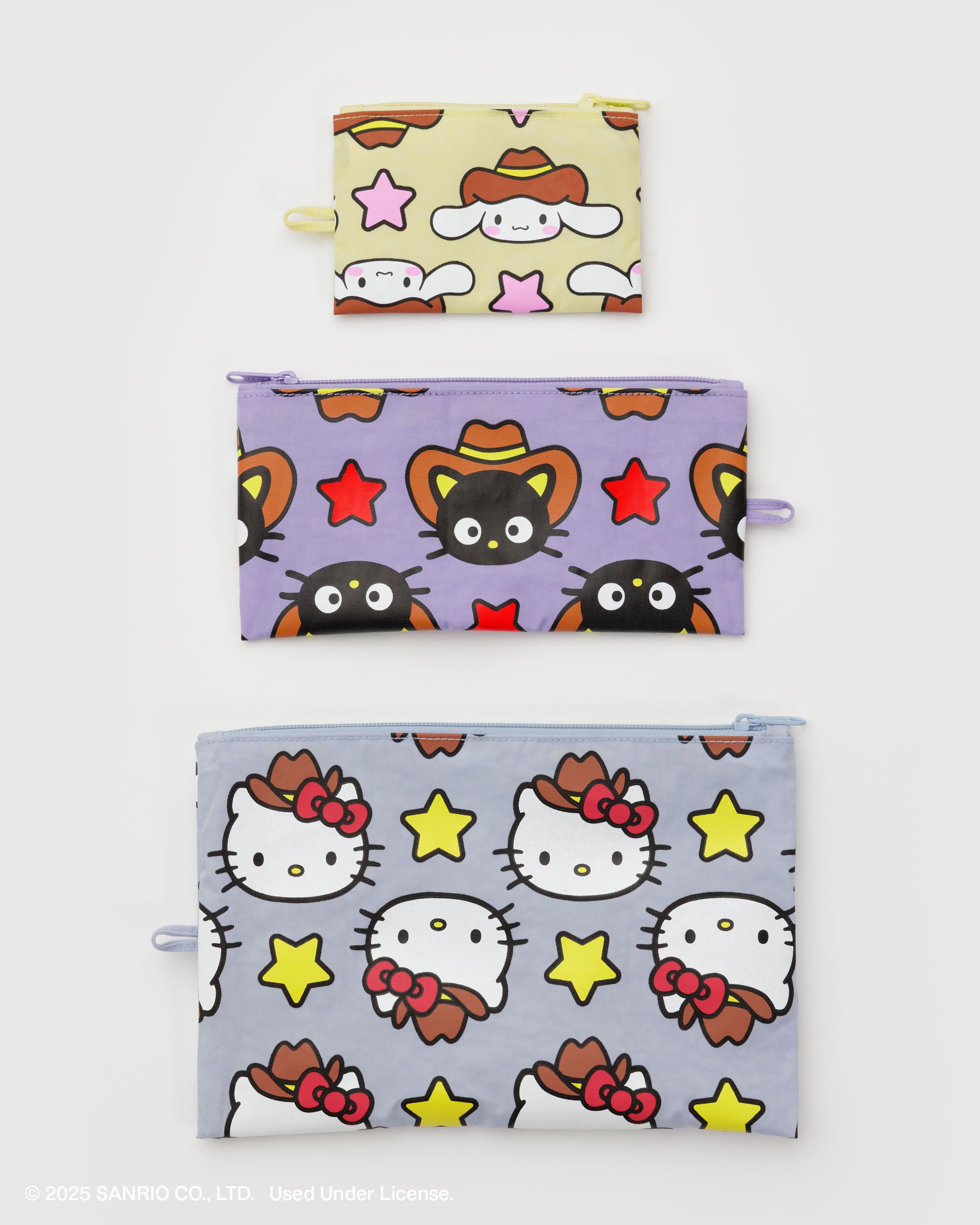 Three flat zip pouches with Hello Kitty western cartoon character patterns.