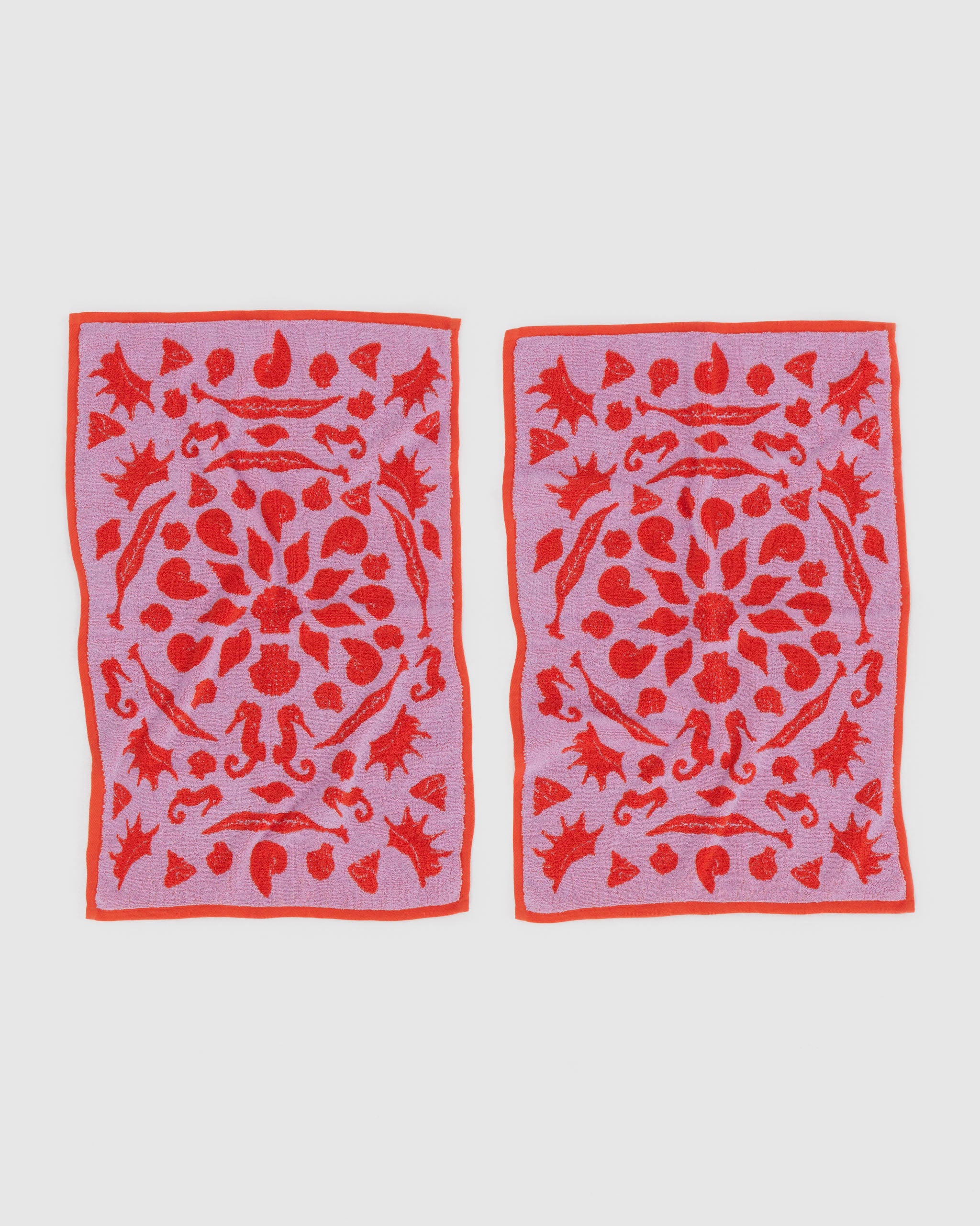 reversible-shell-pattern-on-hand-towels-set-of-two-main-pink-colour-and-contrast-in-red-front-side