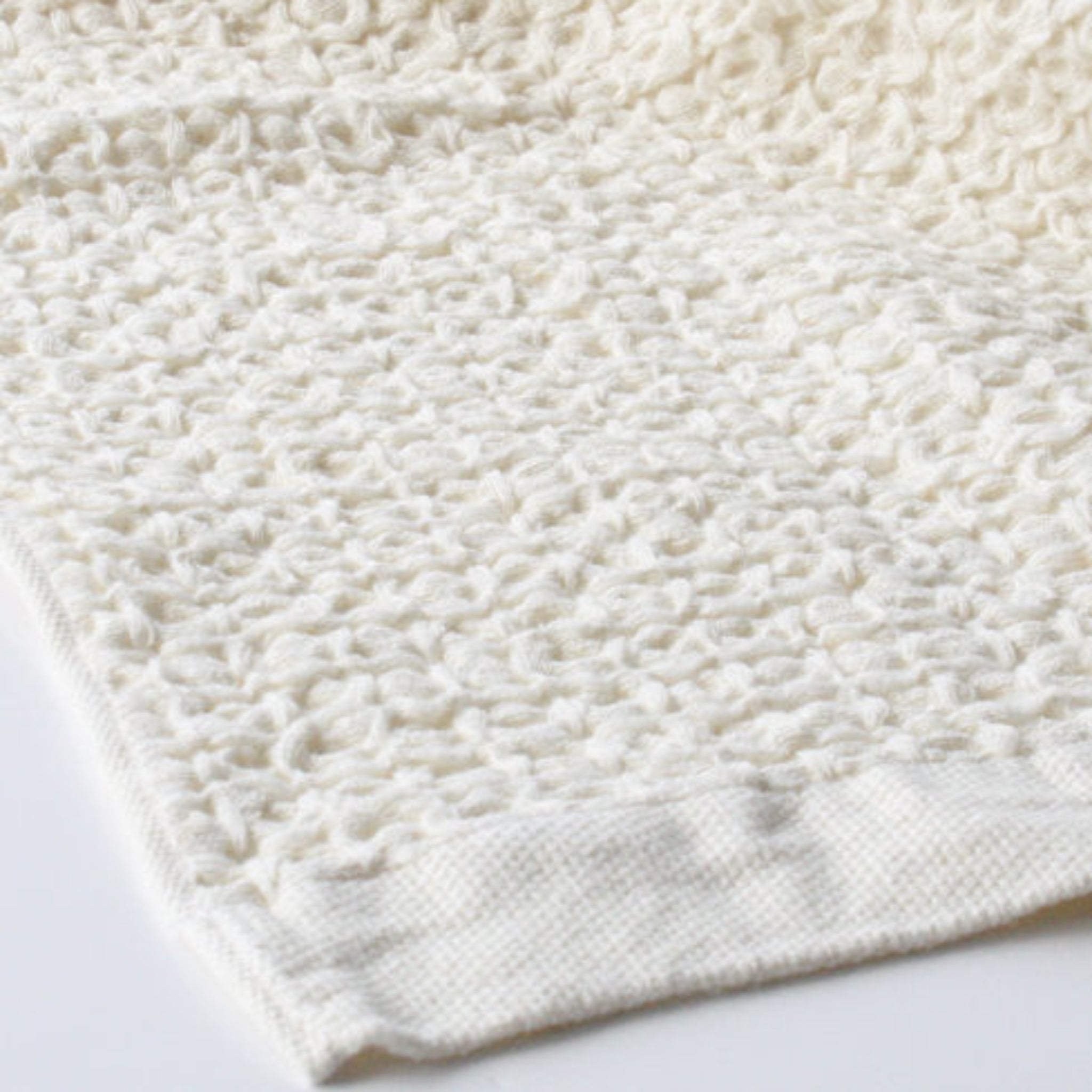 Close-up of waffle textured ivory coloured towel.