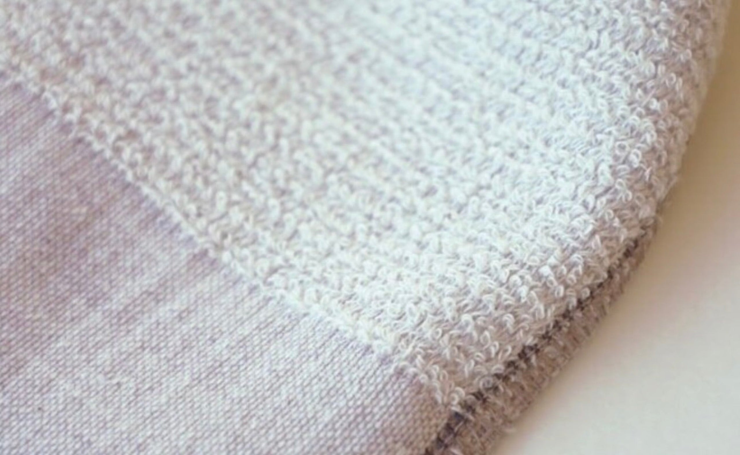 Close-up of textured towel fabric in blueberry colour.