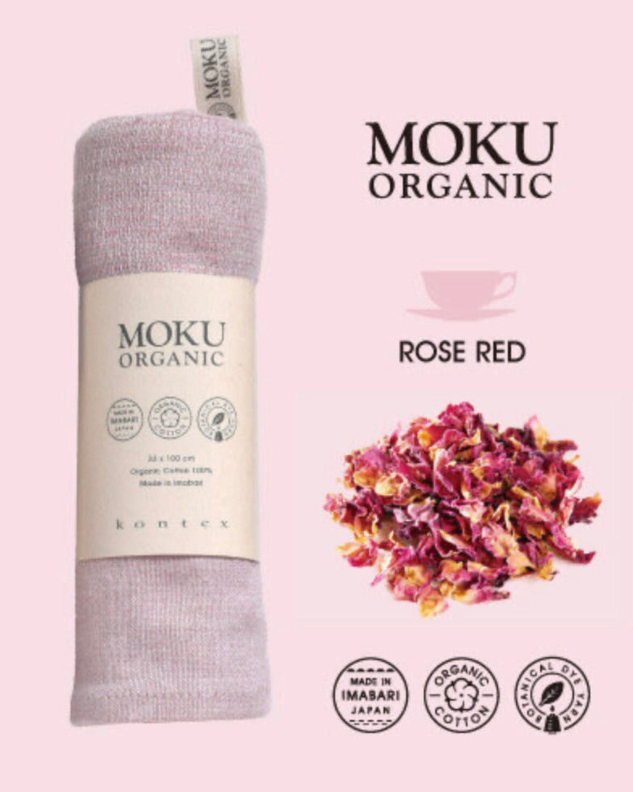 Moku Organic towel wrapped in packaging and rose red tea leaves on a light pink background.