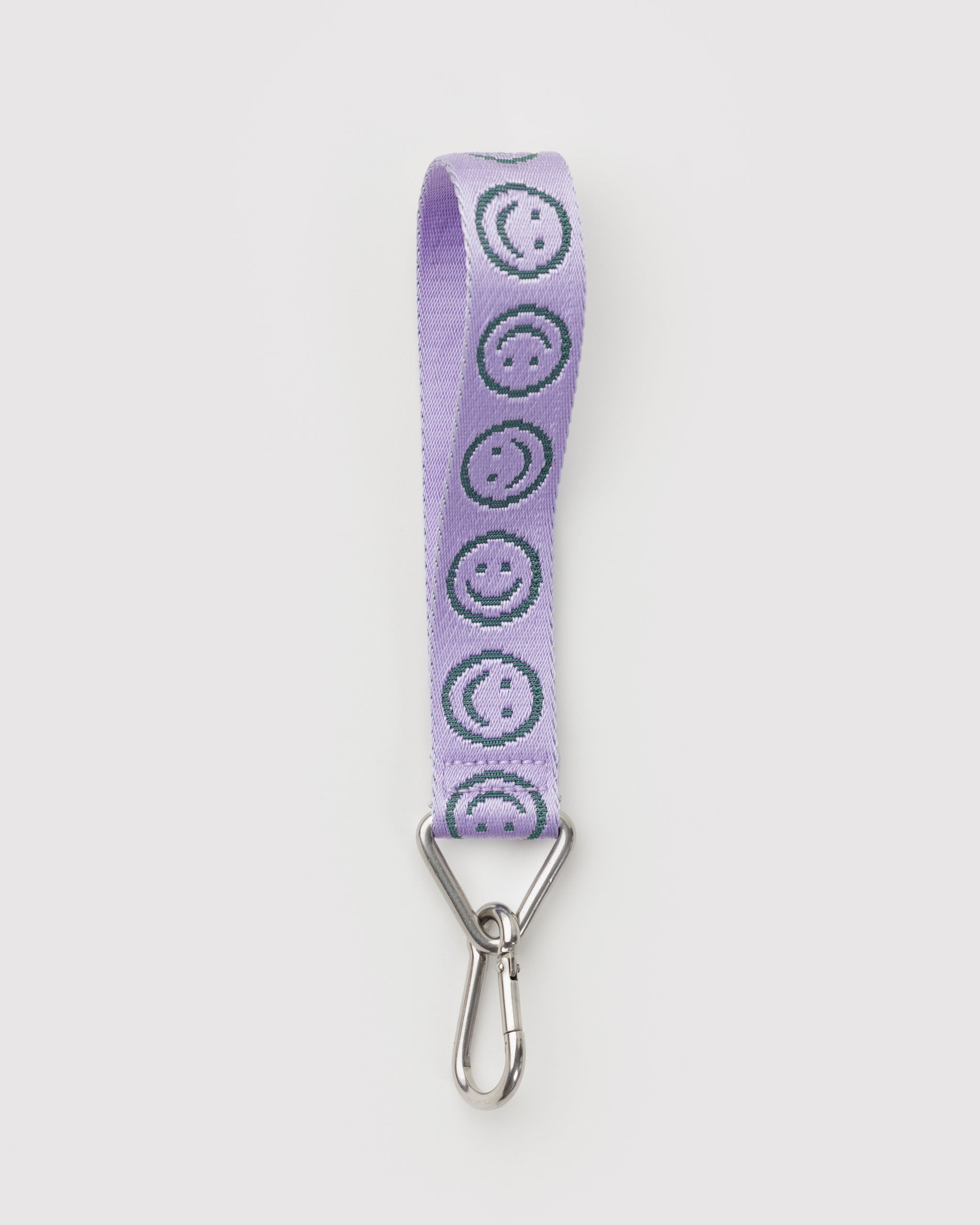 Lavender lanyard with green smiley face pattern and metal clip.
