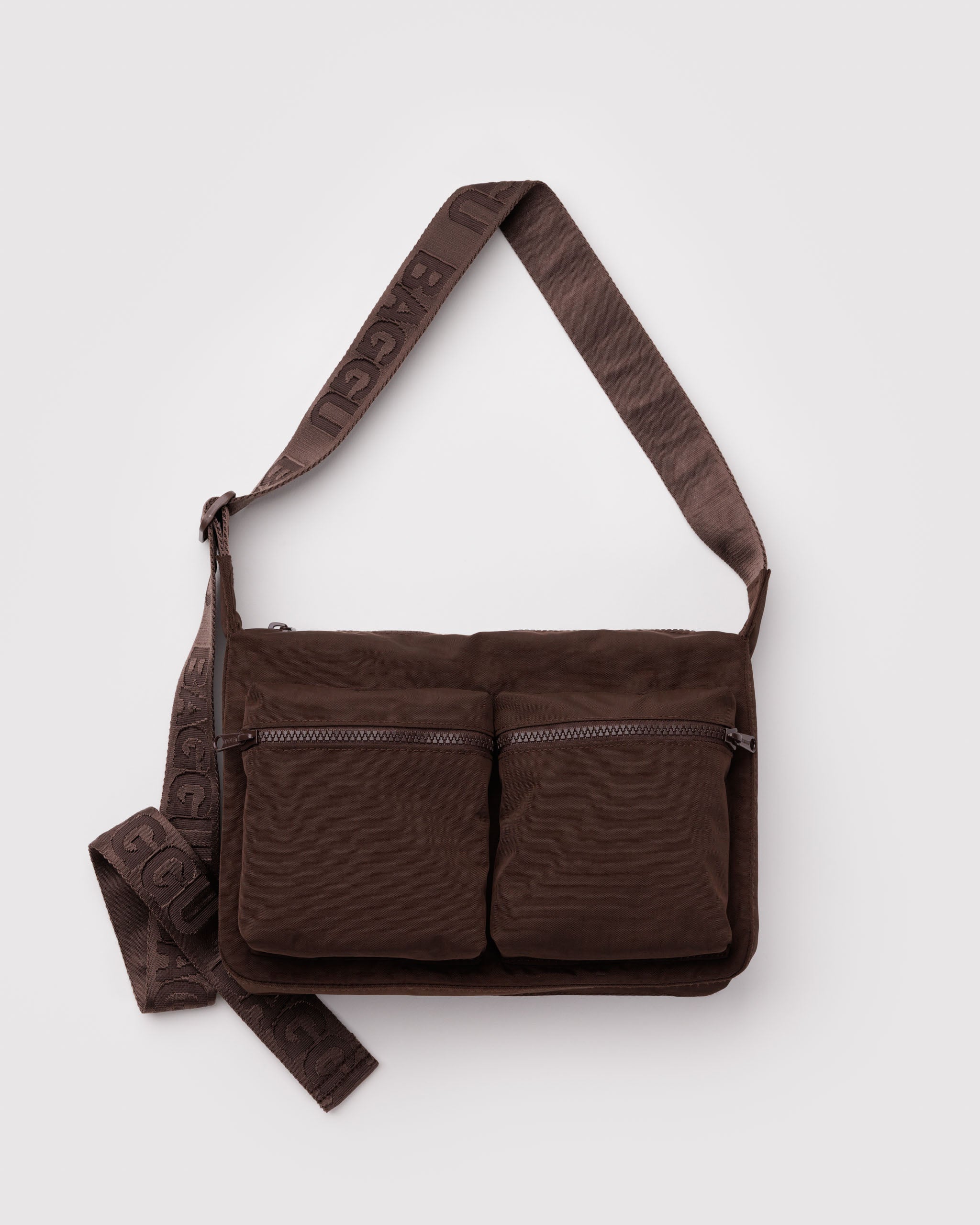 Brown crossbody bag with a wide adjustable strap and front cargo zip pockets.