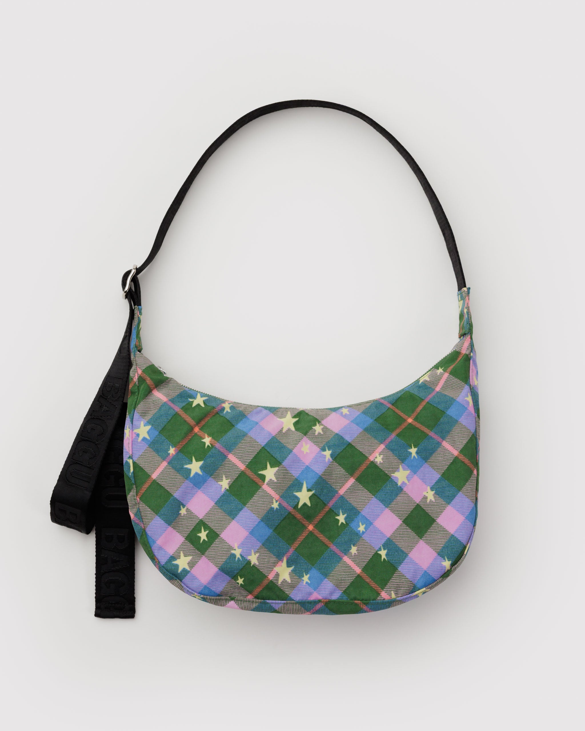 Pink and green plaid patterned crescent bag with yellow stars print and a black adjustable strap.