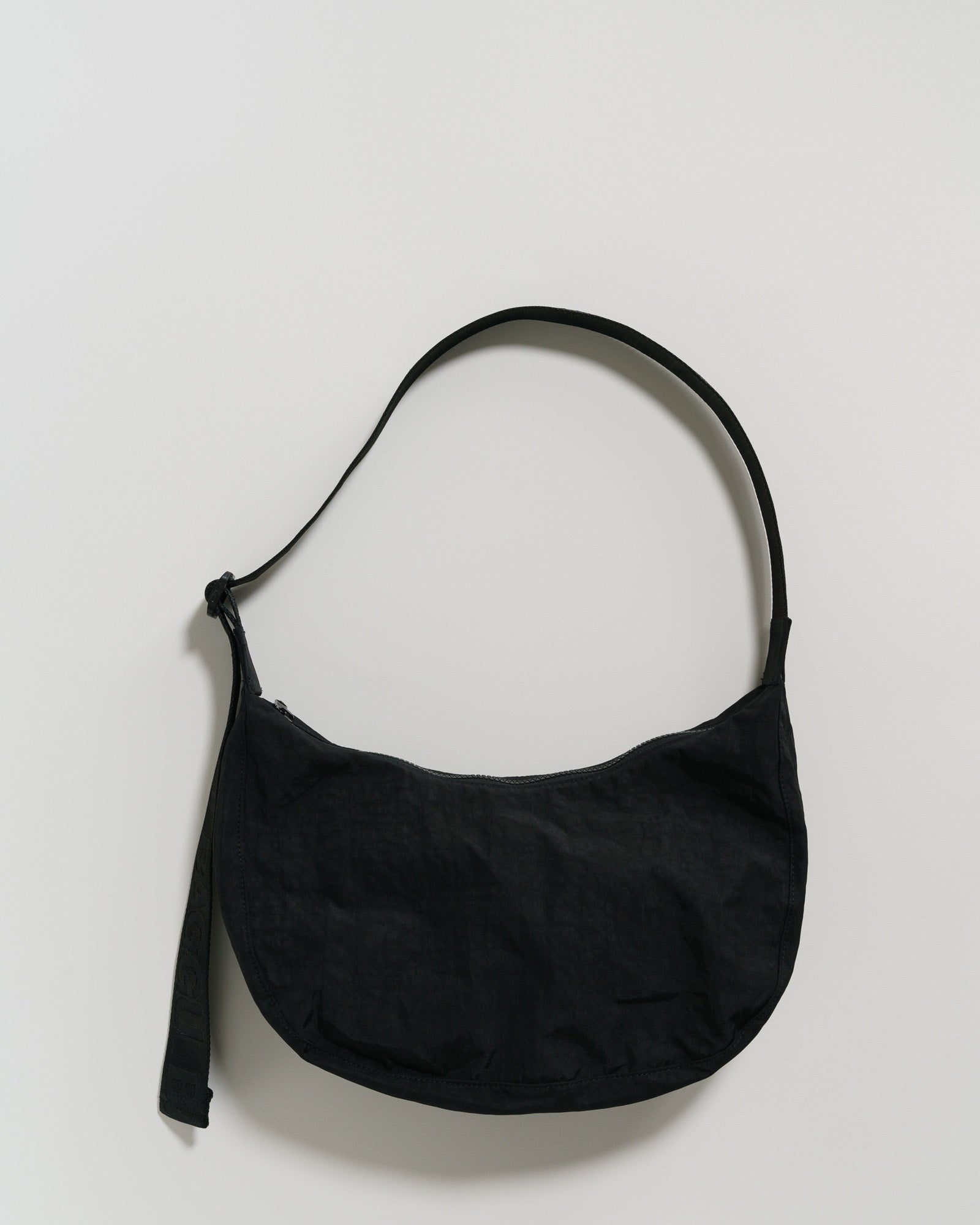 Black shoulder bag with zip top and adjustable shoulder strap