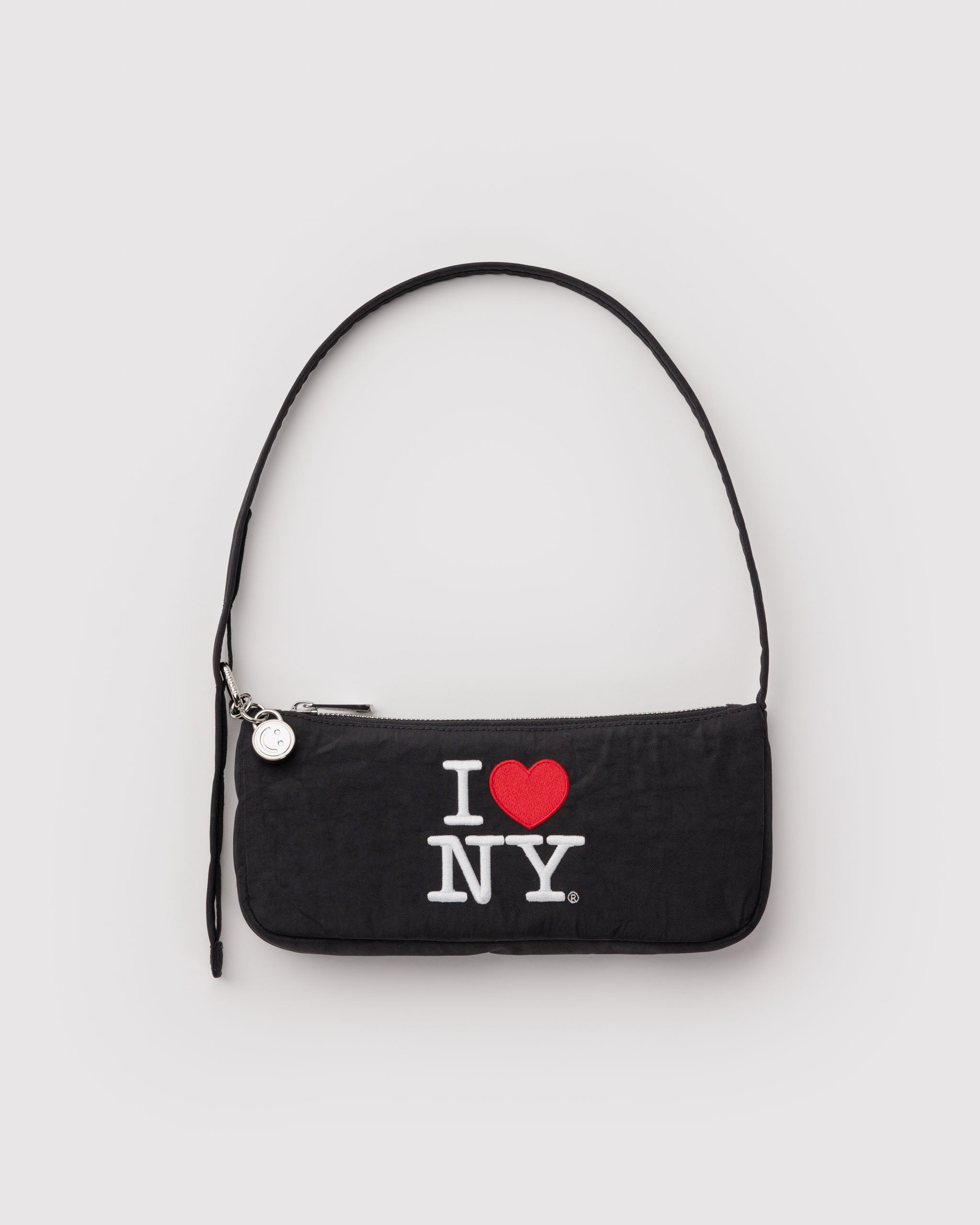 Black purse shoulder bag with 'I ❤️ NY' text embroidered on the front with a metal zip and smiley face charm and adjustable carry handle.