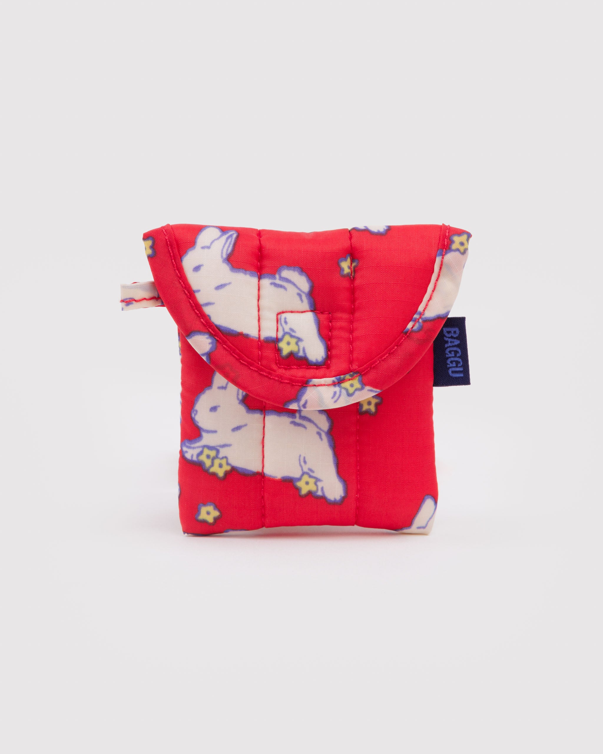 Red pouch with white bunnies, hanging loop and BAGGU logo tag.