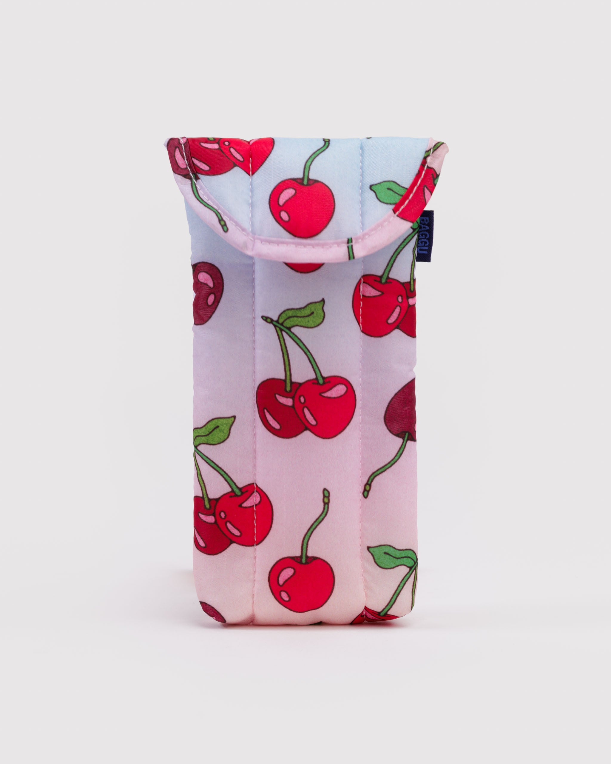 Small quilted and puffy pouch with cherry pattern on a light pink and blue background.