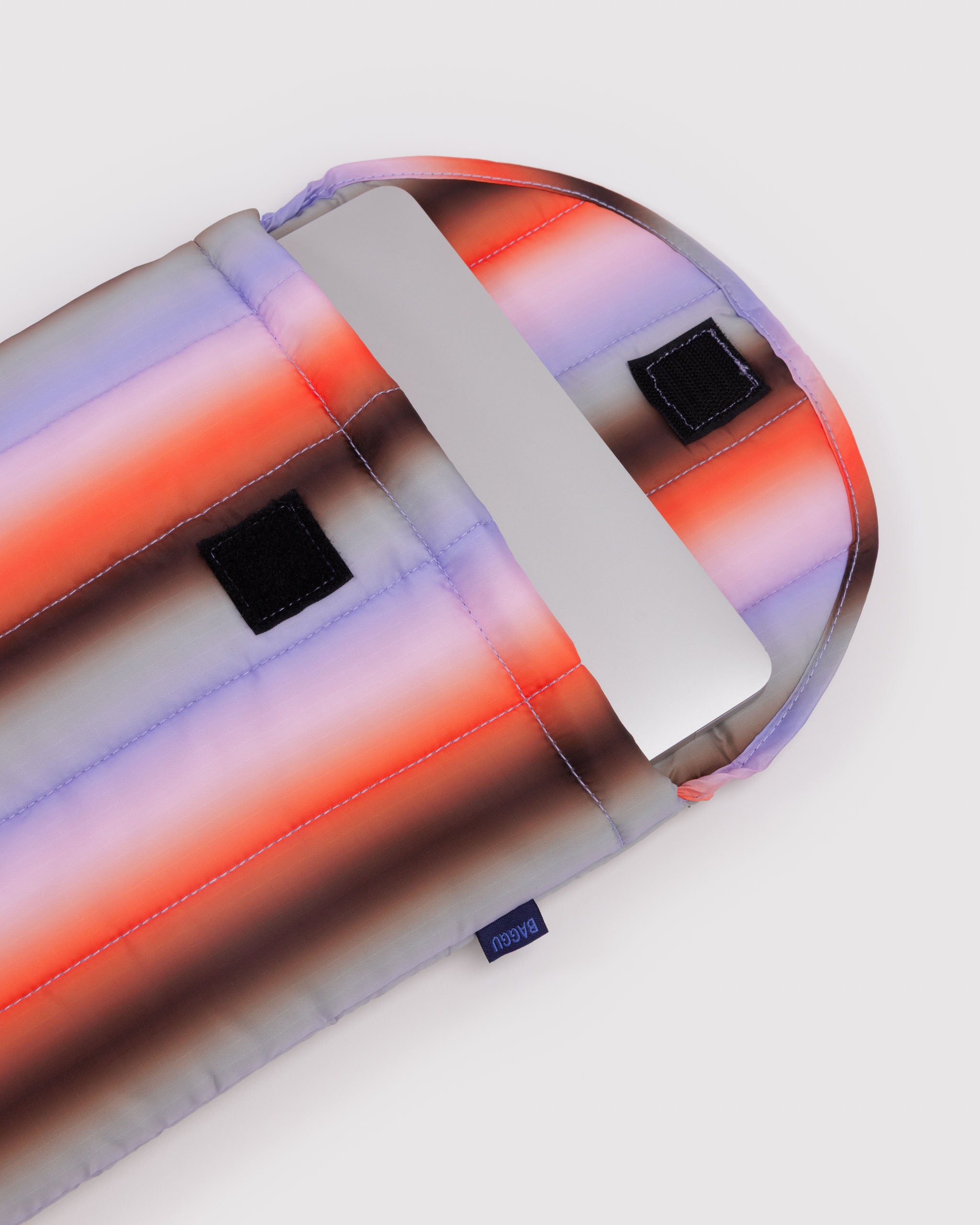 Gradient-colored pouch with a reflective surface on a white background