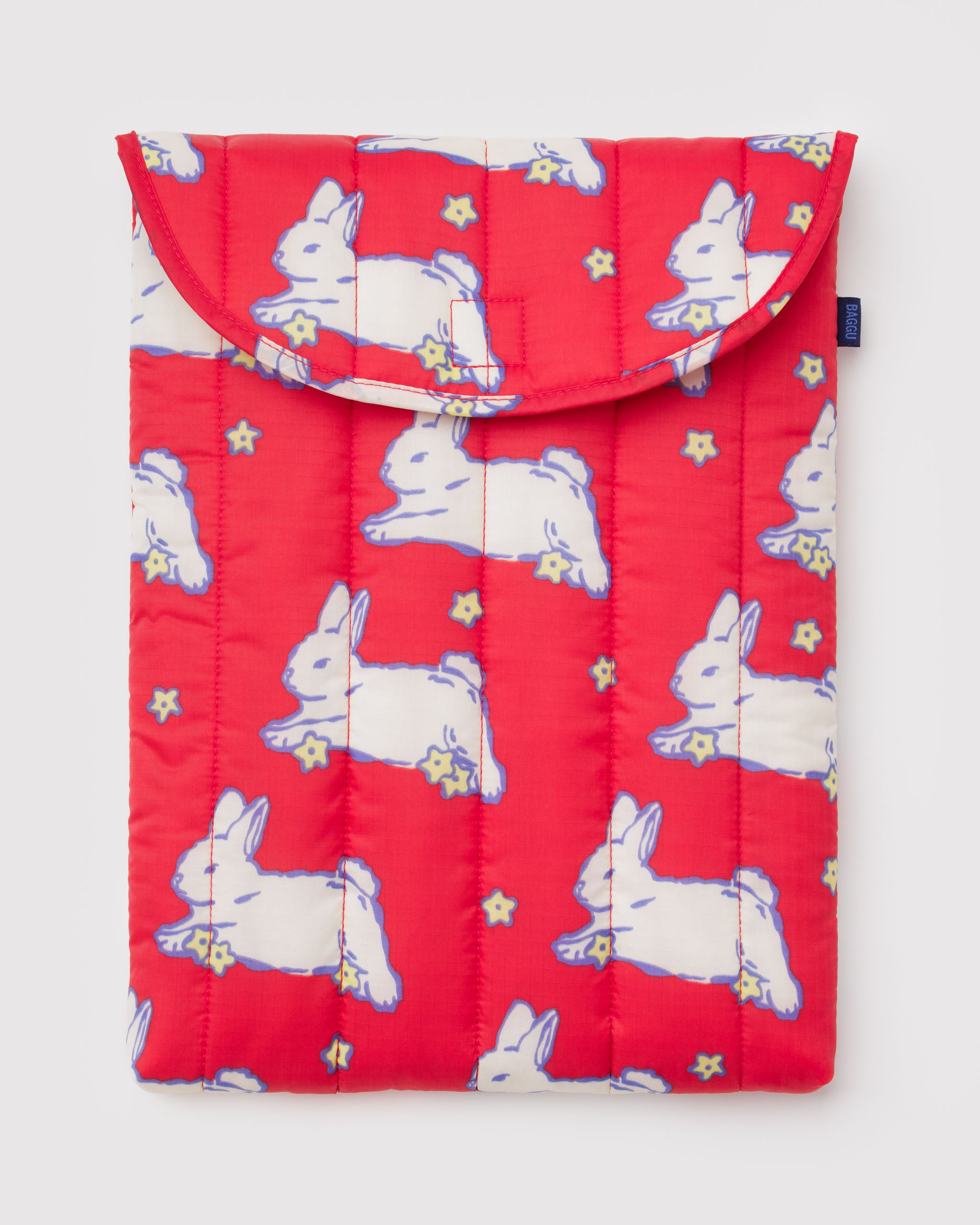 Red quilted and puffy sleeve with white rabbit and yellow flowers pattern.