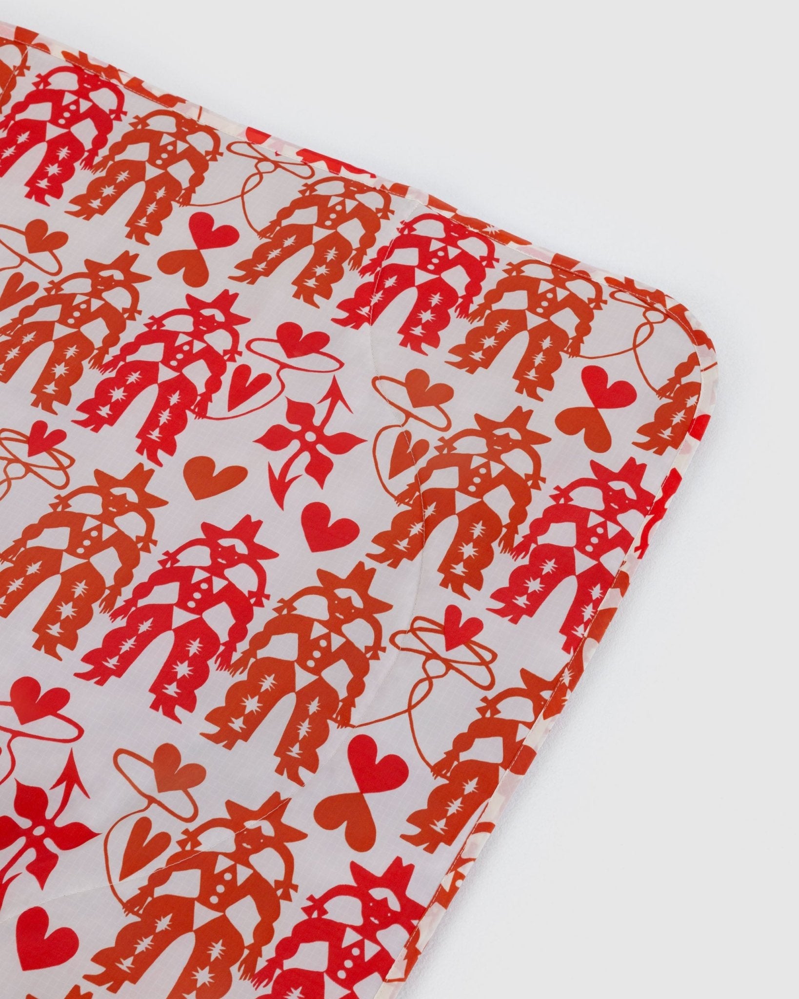 Baggu Puffy Picnic Blanket in a cowgirl and hearts pattern