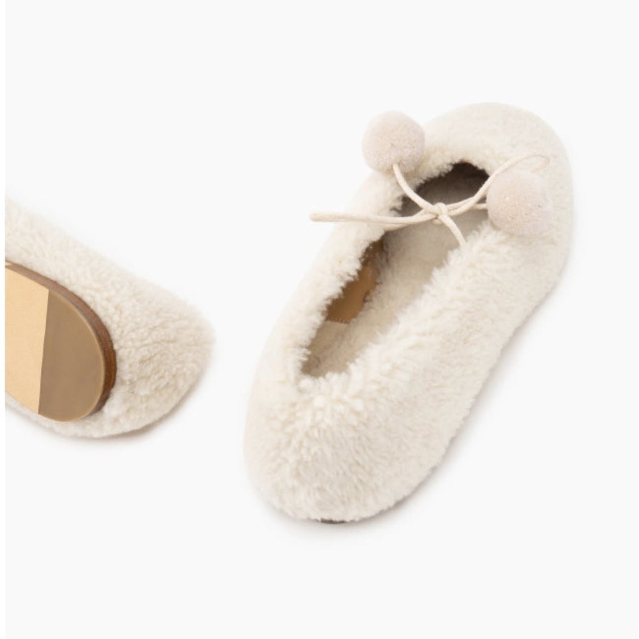Cream fluffy sheepskin slippers with pom-pom ties.