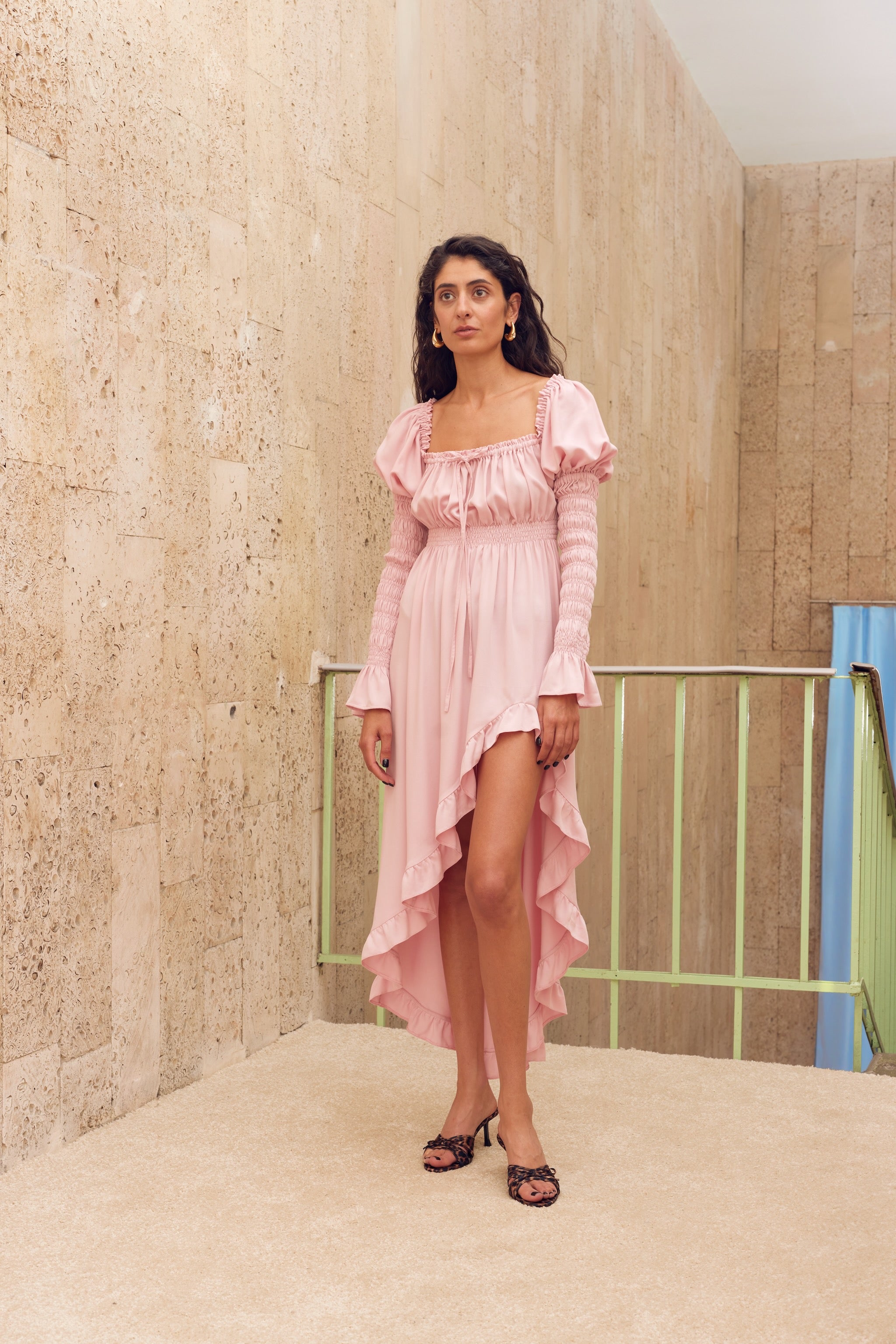 woman standing-showing-side-slit-of-pink-shirred-dress