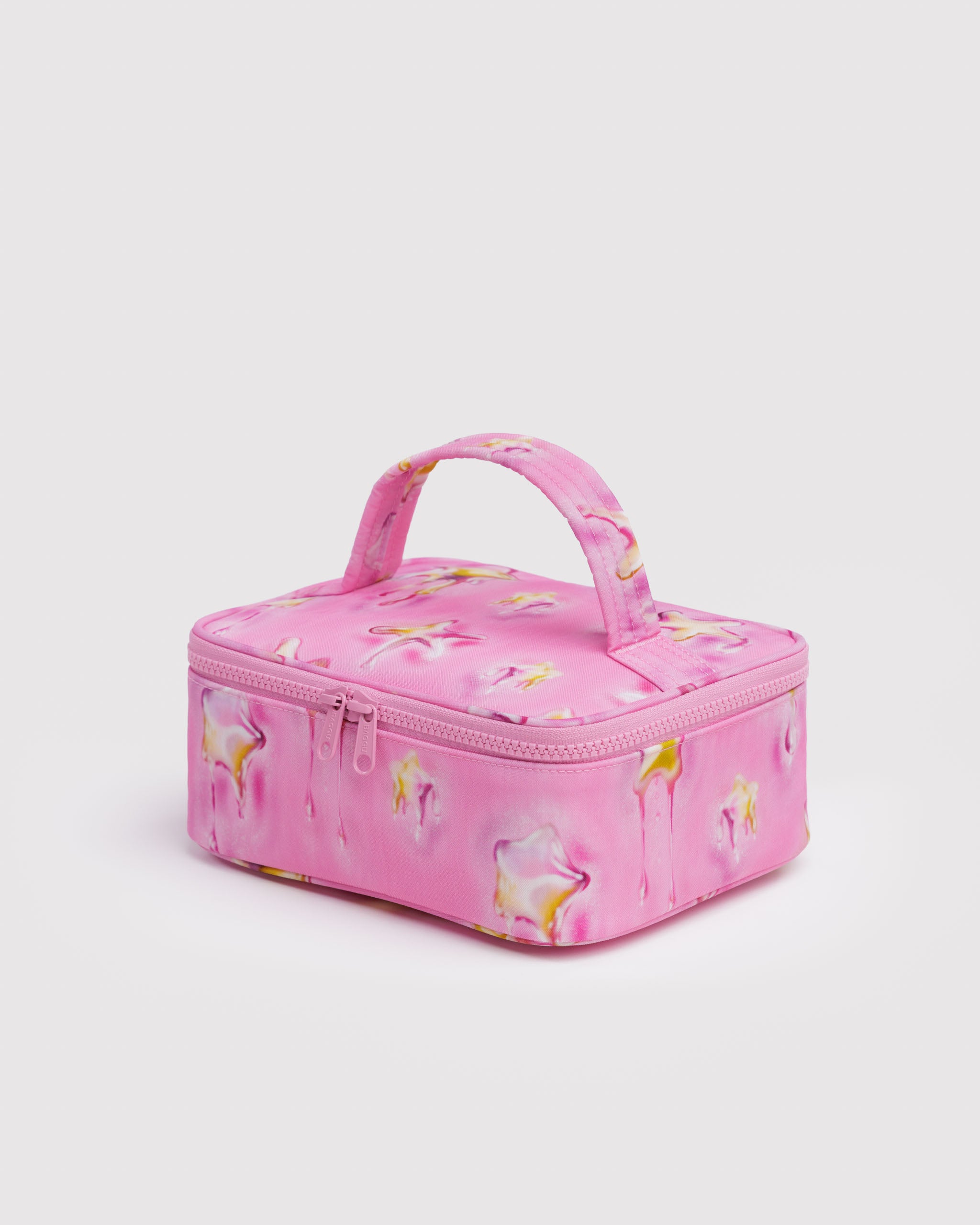 Pink small cosmetic case with yellow melting stars all over design with matching handle and tonal pink zip closure.