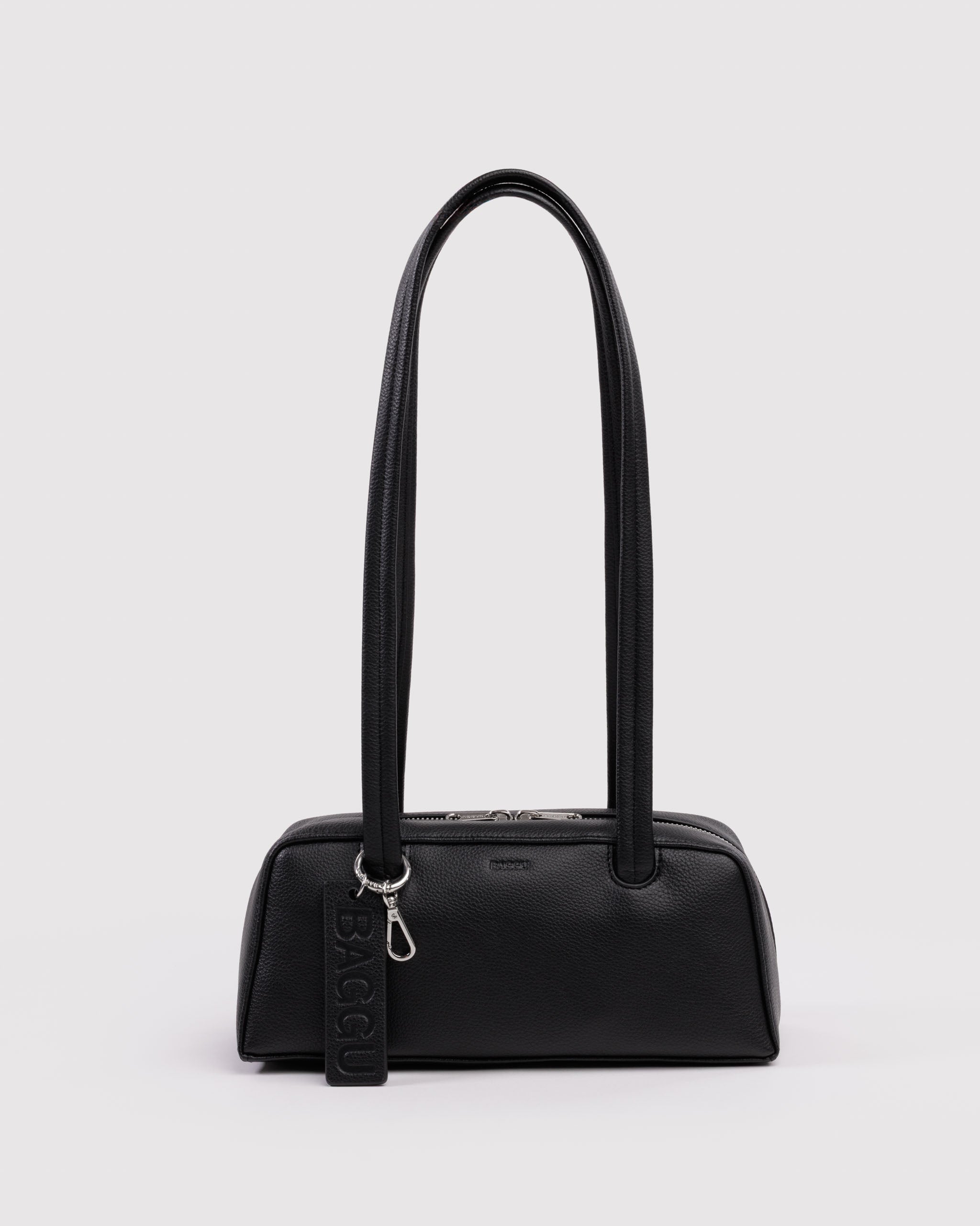 Black handbag with double long straps, metal clip attached to one of the straps and a leather BAGGU logo tag and double metal top zippers.