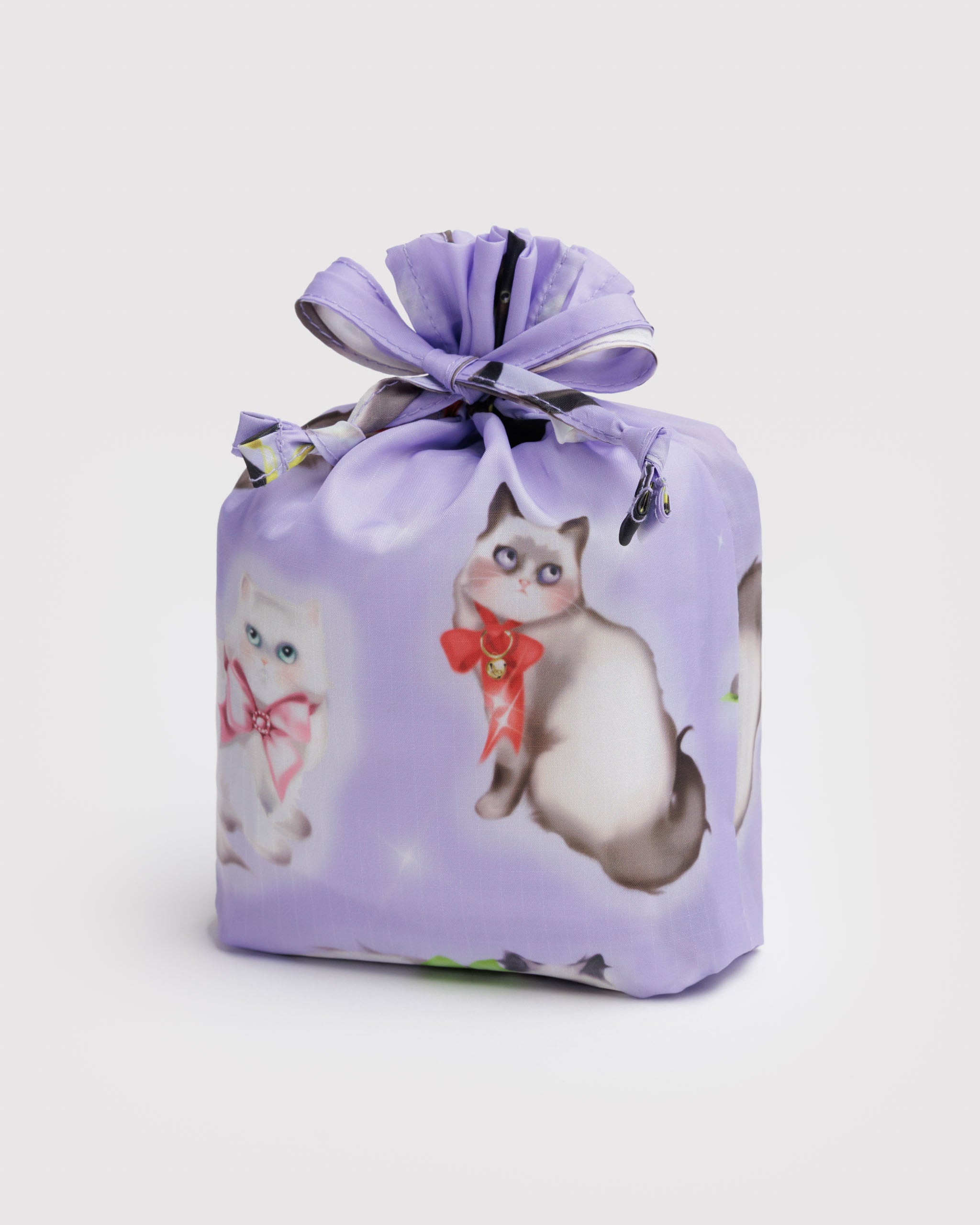 Light purple drawstring pouch in fancy animal print of cats illustrations with 3 reusable bags inside.