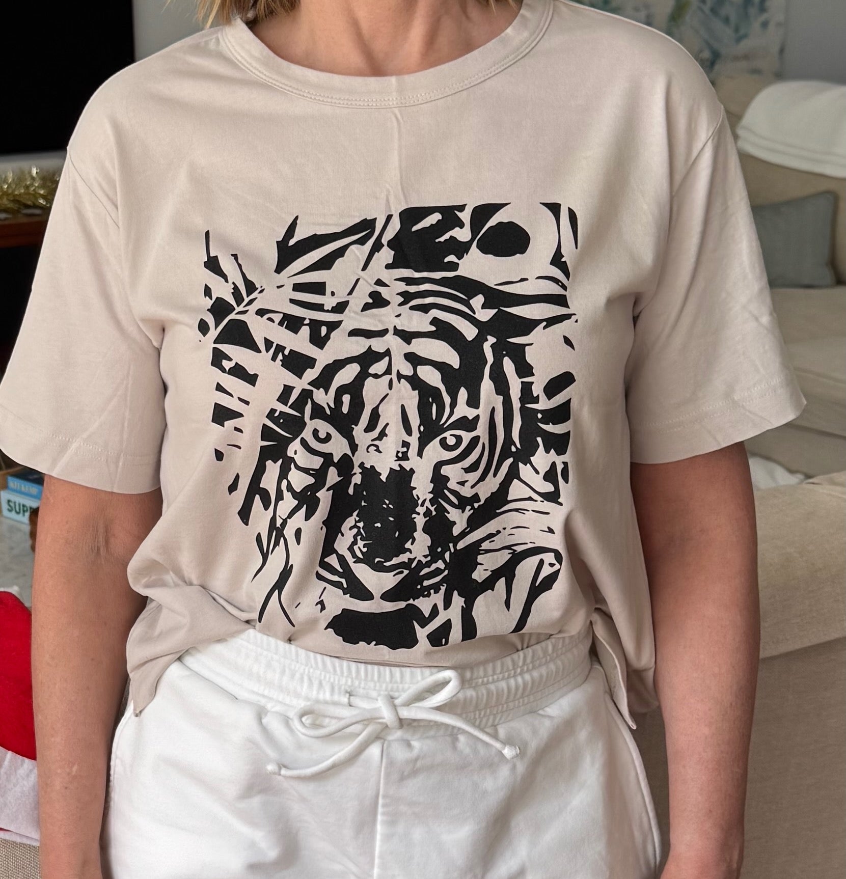 woman-wearing-bone-tiger-tee-and-white-shorts