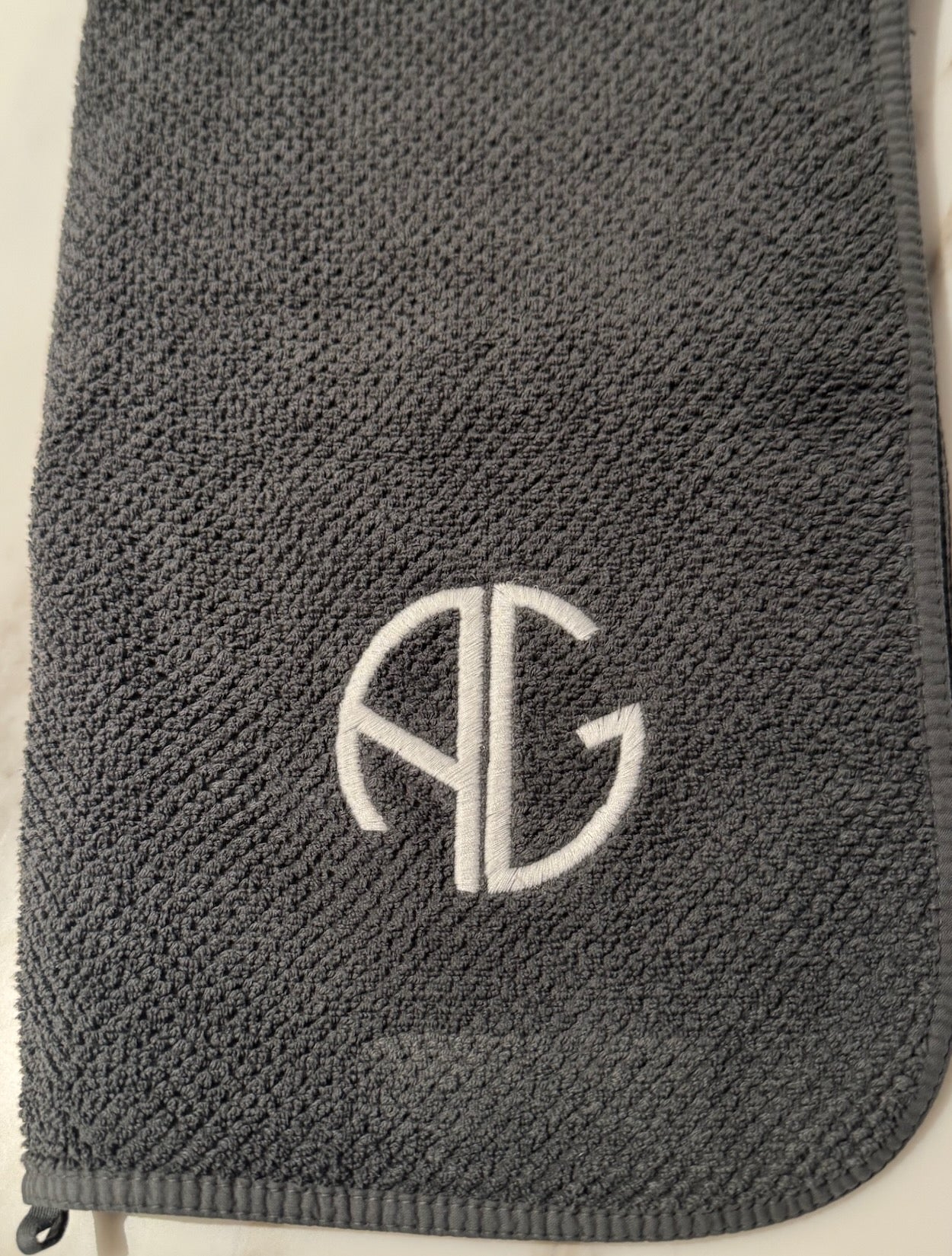 White AG embroidered logo on storm coloured AG Waffle Sports Towel - ANNIE.G
